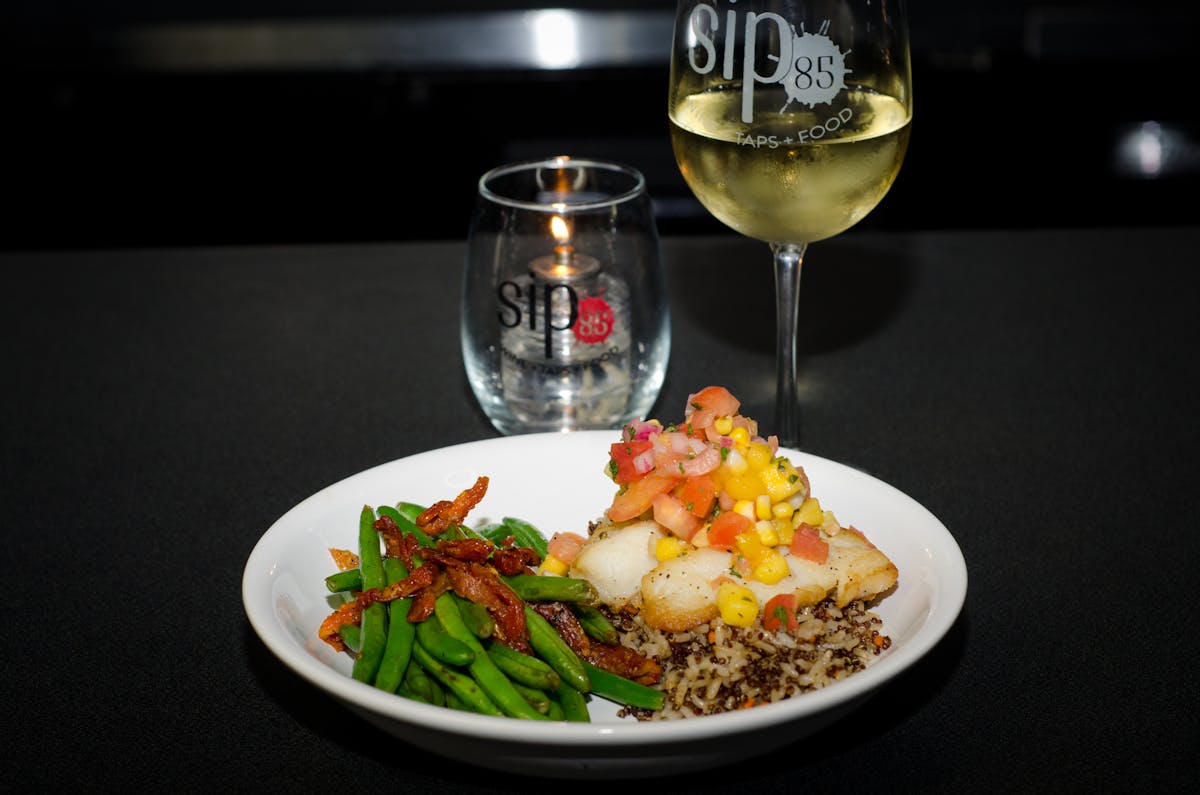 a plate of food and a glass of wine