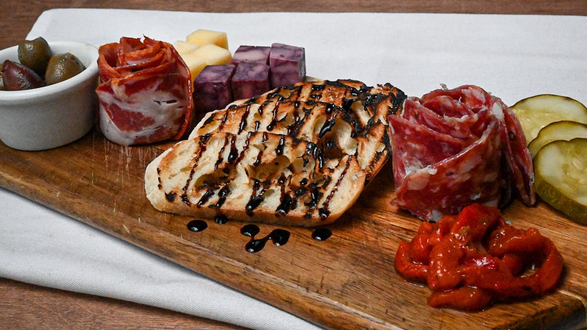 a plate of food sitting on top of a wooden table