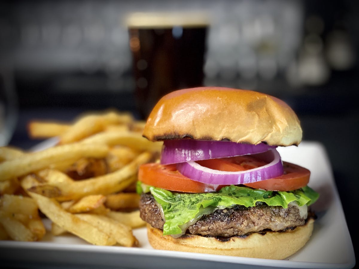 a close up of a sandwich and fries on a plate