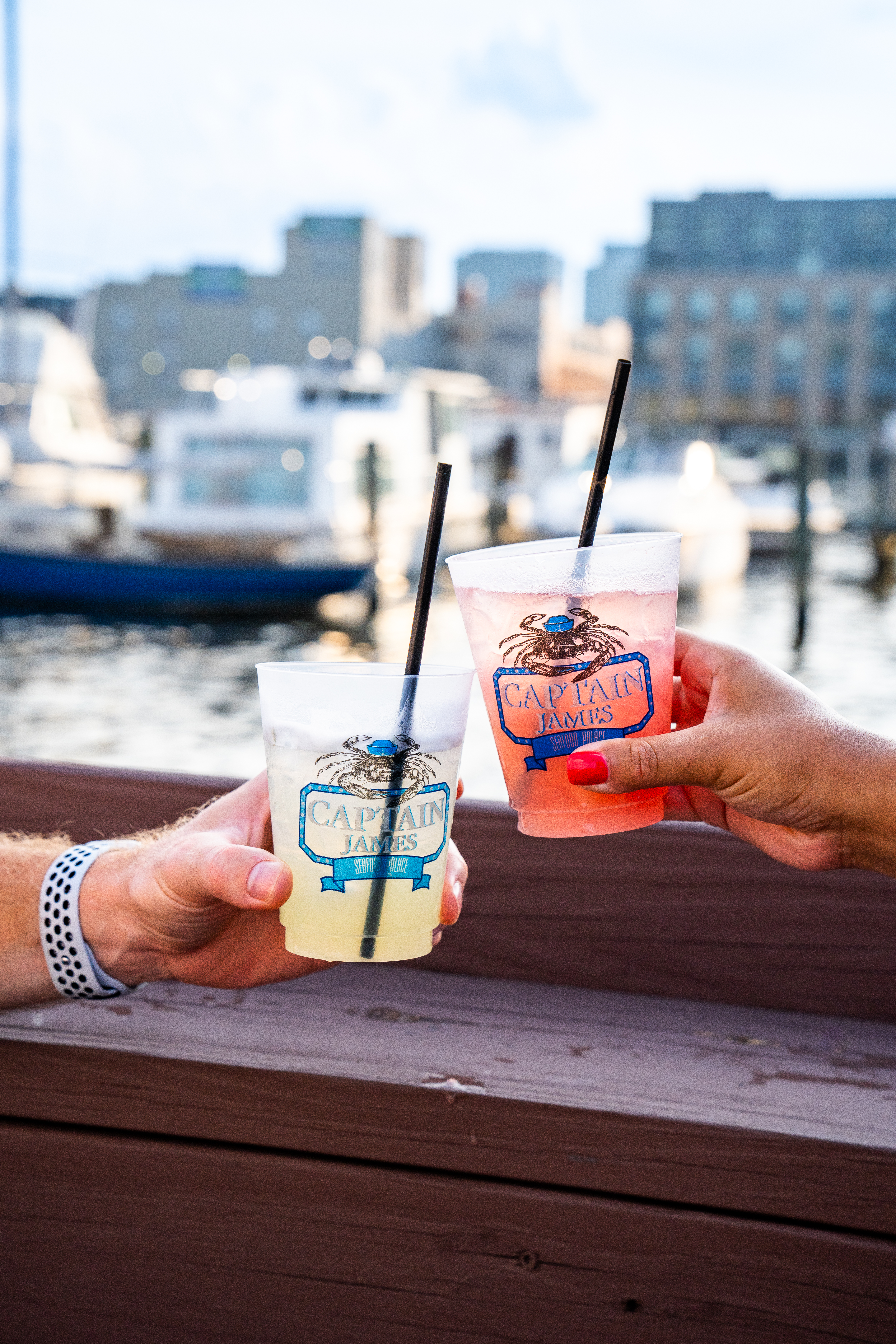 a hand holding a water bottle on a table