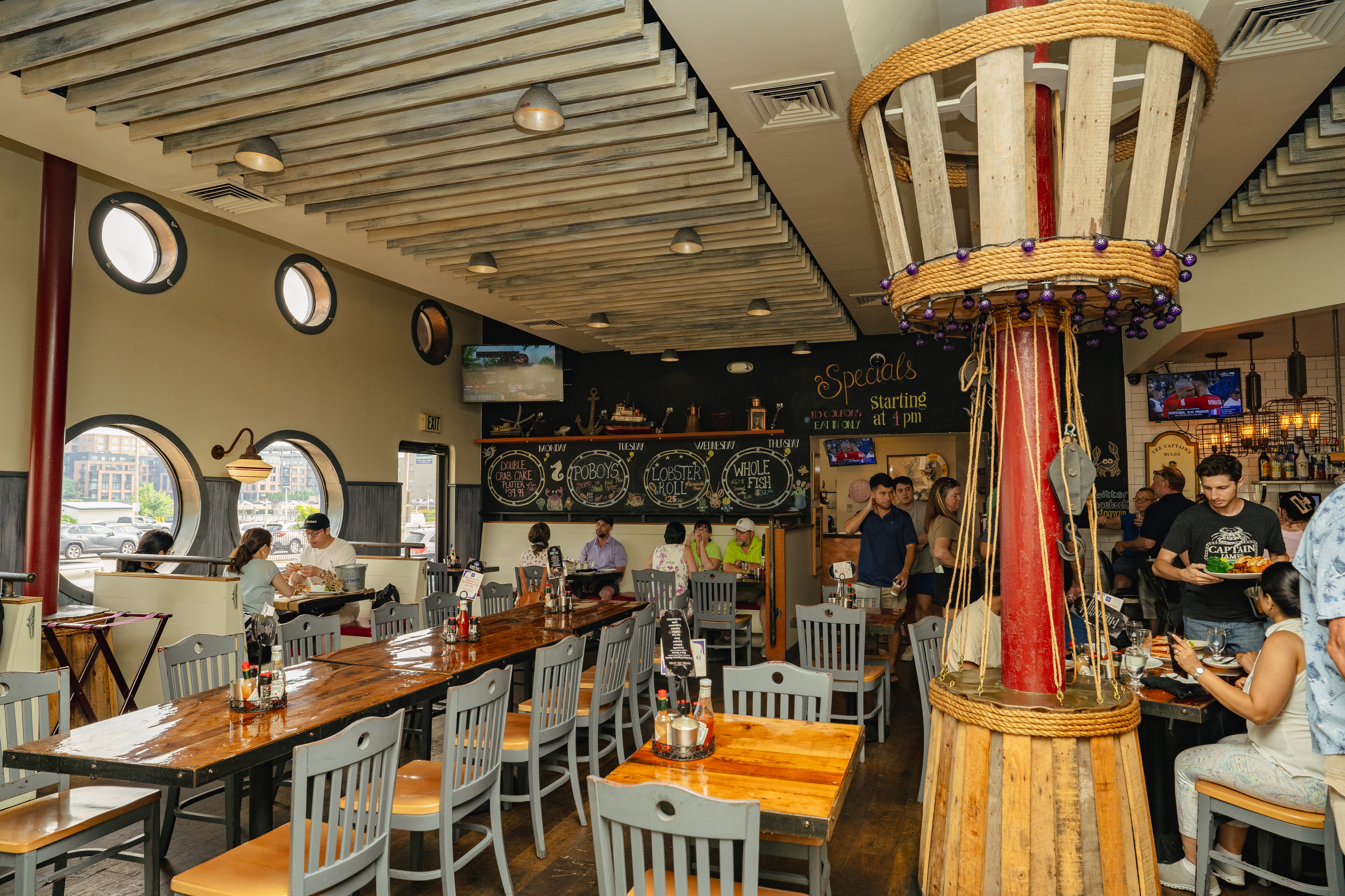 a group of people sitting at a table in a restaurant