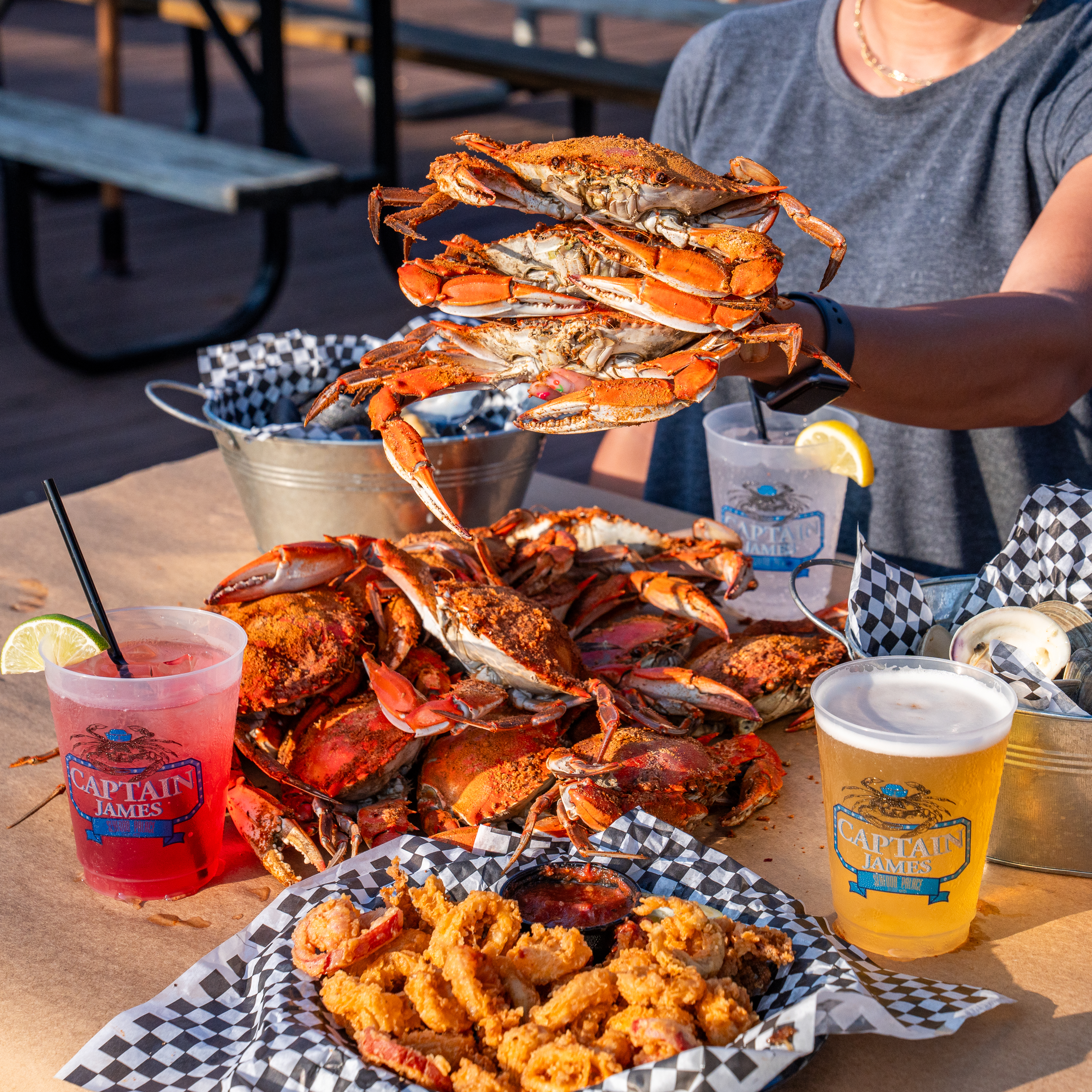 a person sitting at a table with a plate of food