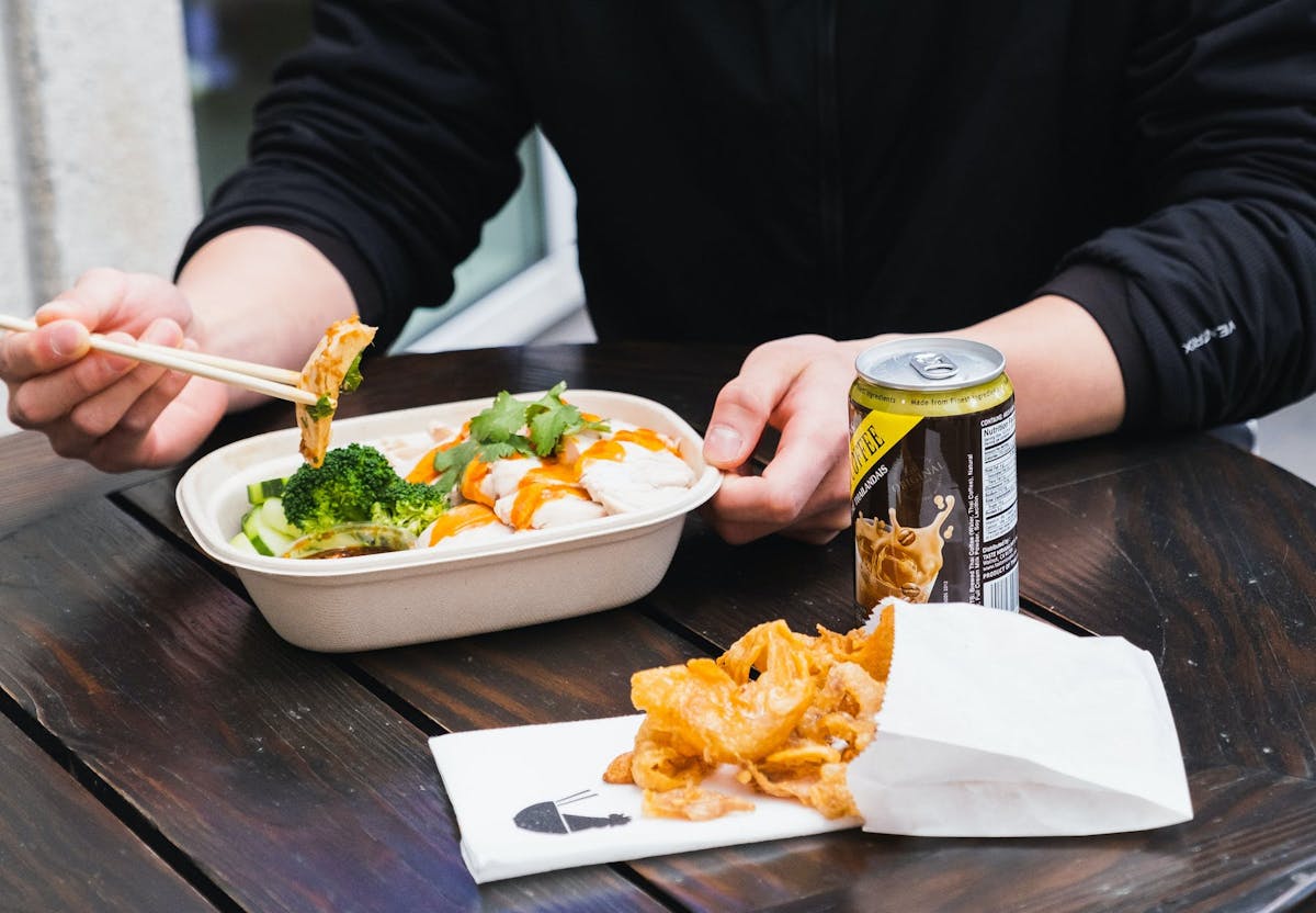 a woman sitting at a table with a plate of food
