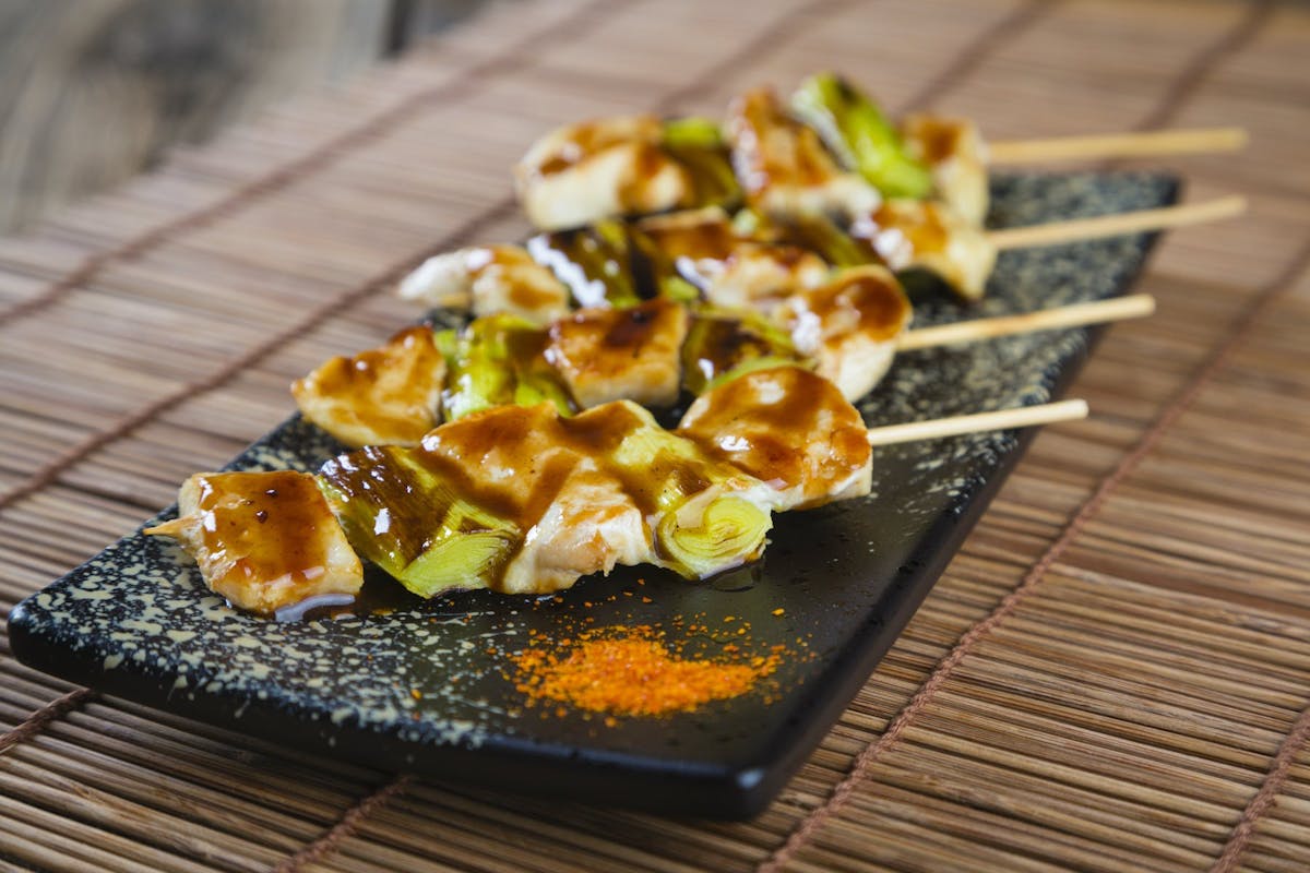 a slice of pizza sitting on top of a wooden cutting board