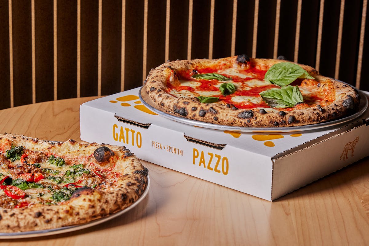 a pizza sitting on top of a wooden table