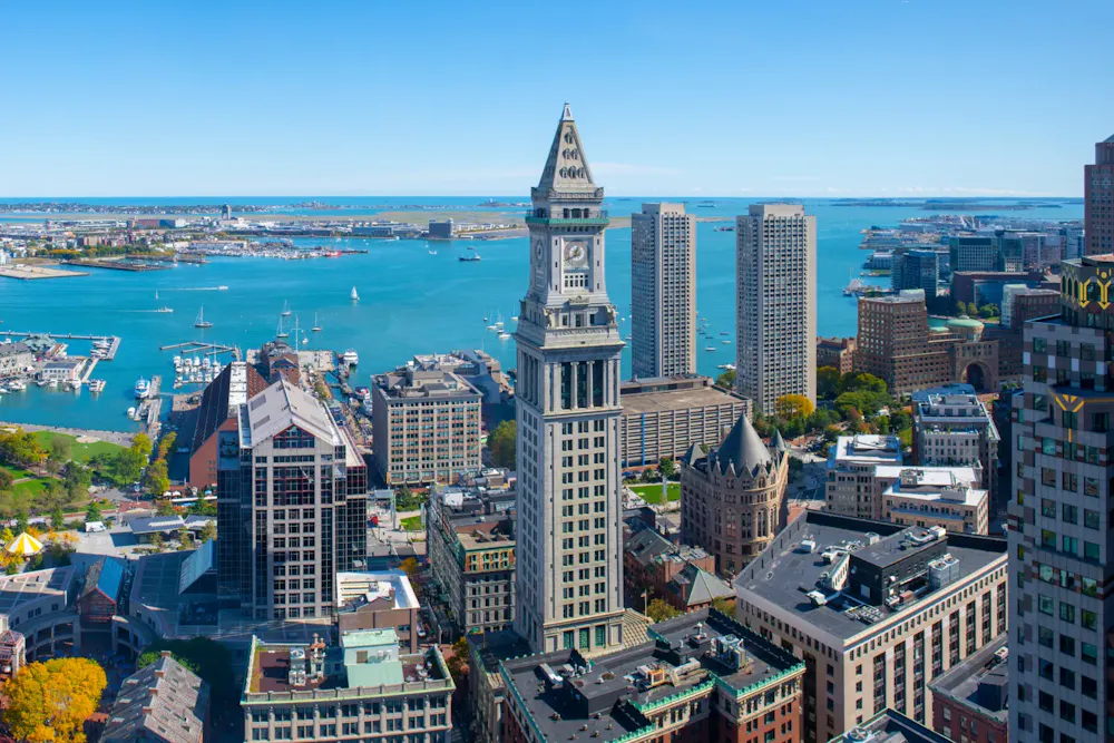 Aerial view of Boston Financial District with Custom House Tower and downtown skyline on a clear day.