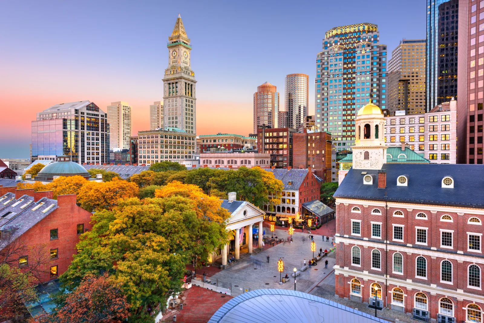 Boston Financial District skyline at sunset overlooking historic buildings in downtown Boston.