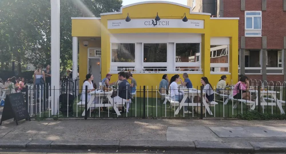 a group of people sitting at a bus stop