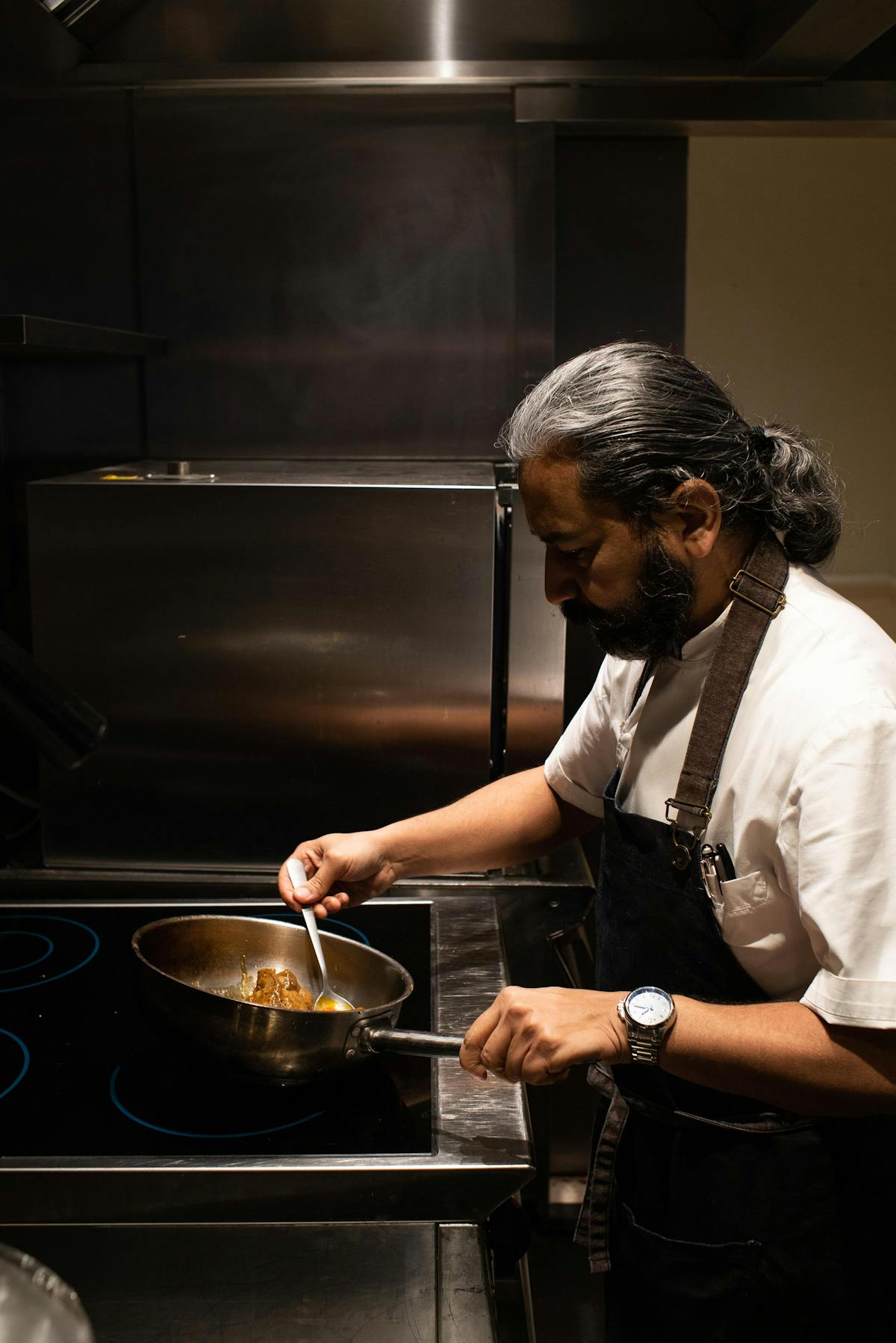 a person cooking in a kitchen preparing food