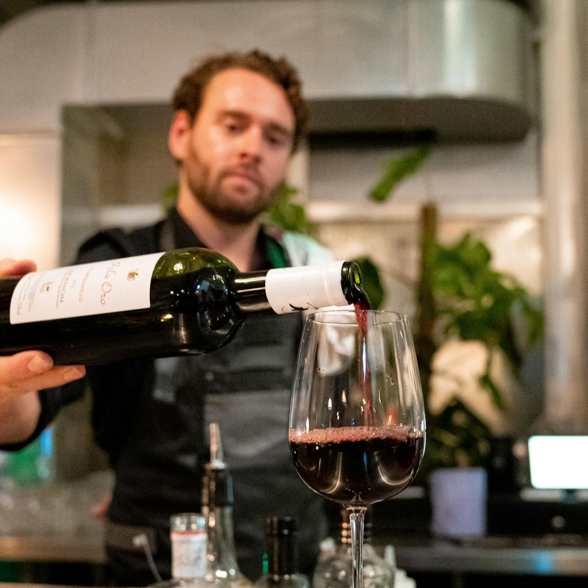 a man holding a bottle of wine