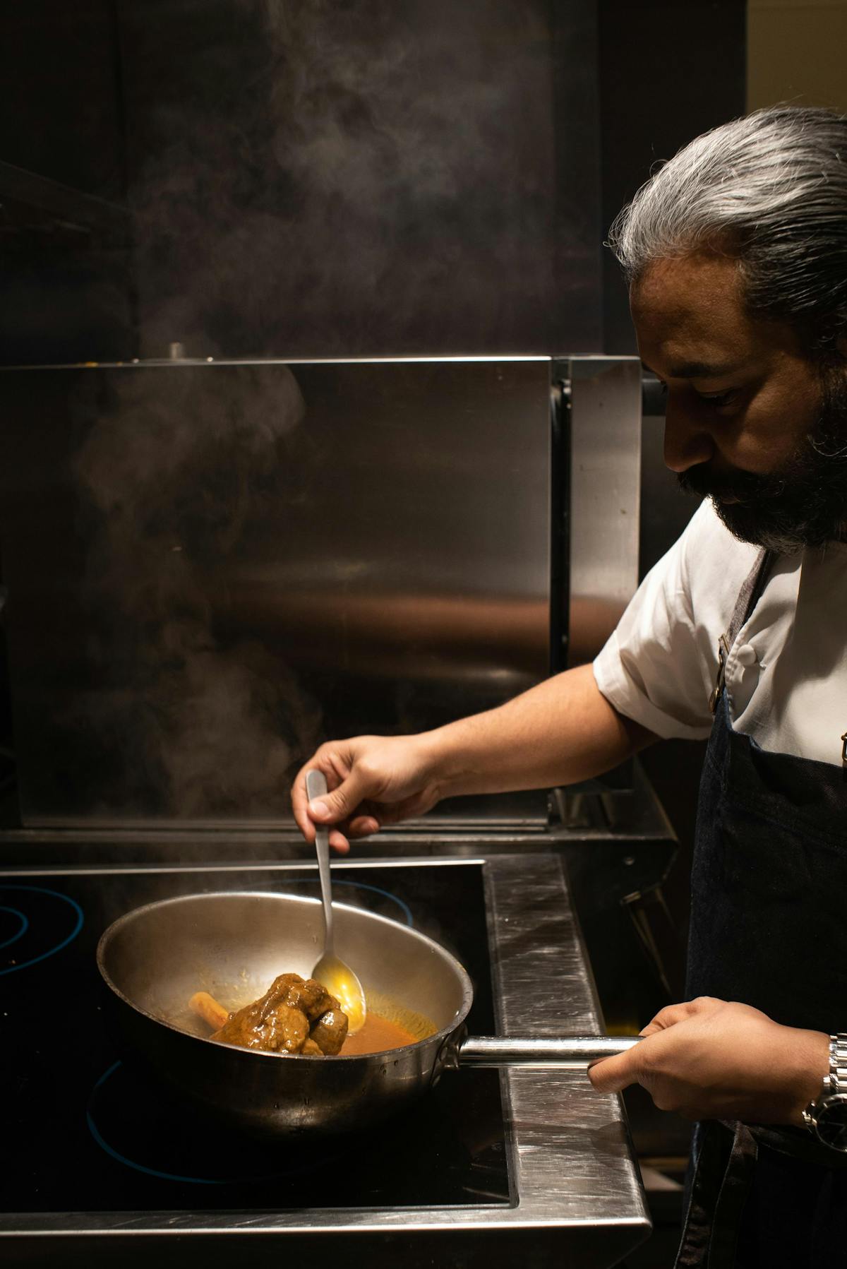 a person cooking in a kitchen preparing food