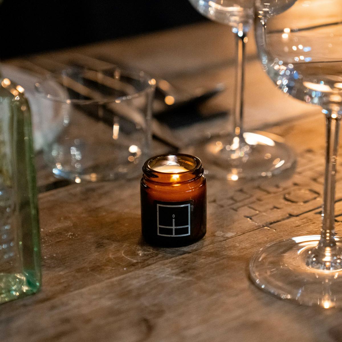 an empty glass on a table with wine glasses