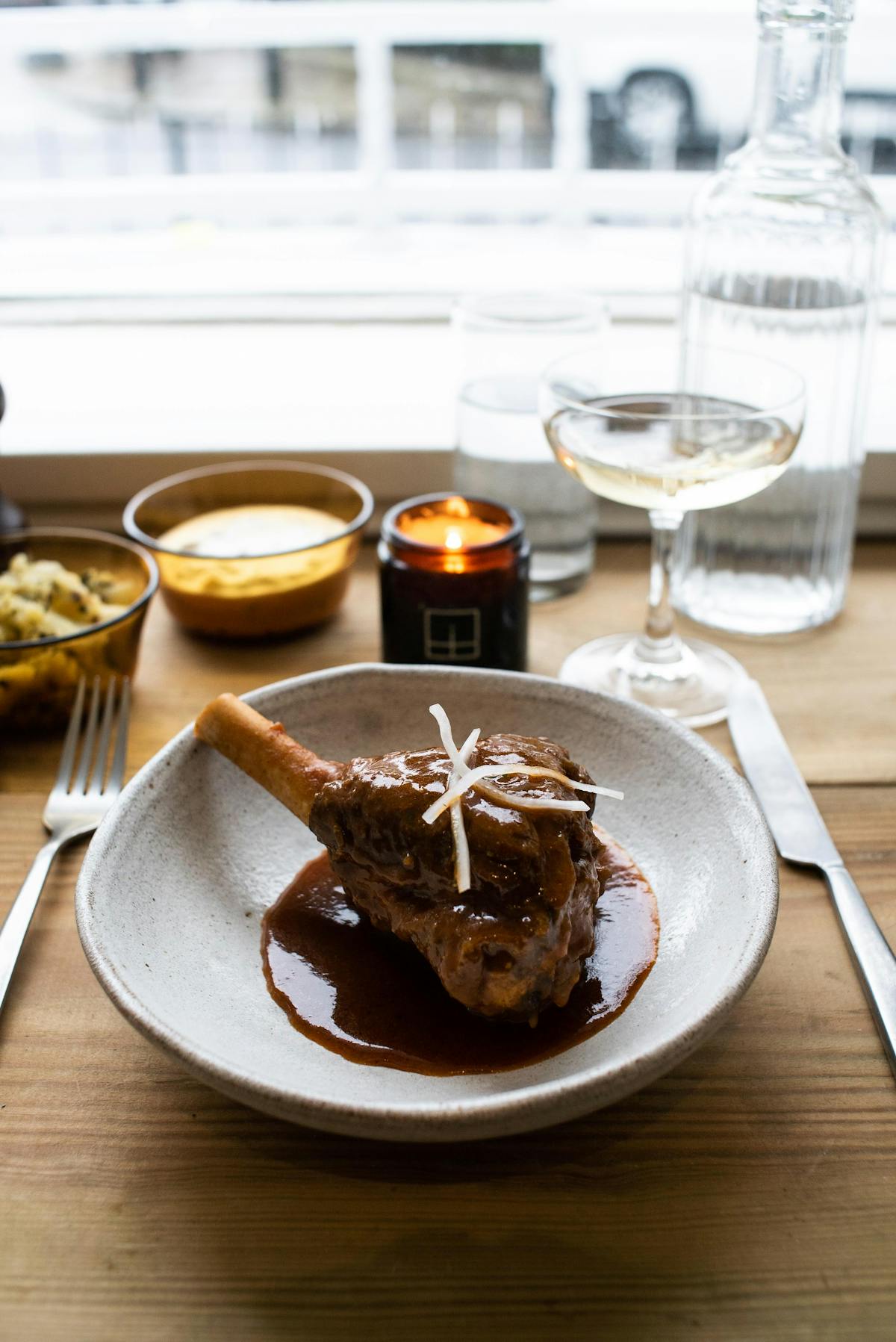 a plate of food sitting on top of a wooden table