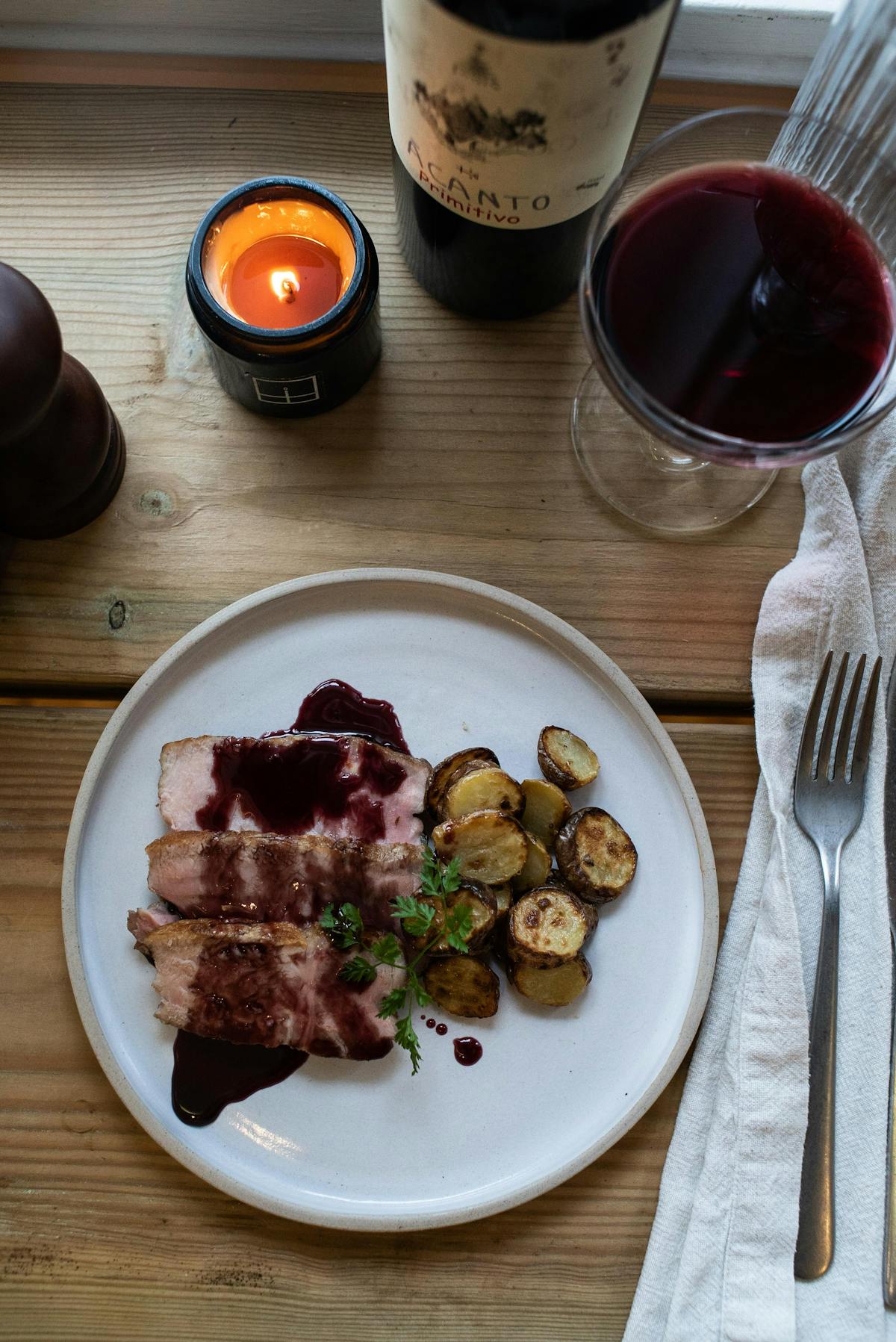 a plate of food and a cup of coffee on a wooden table