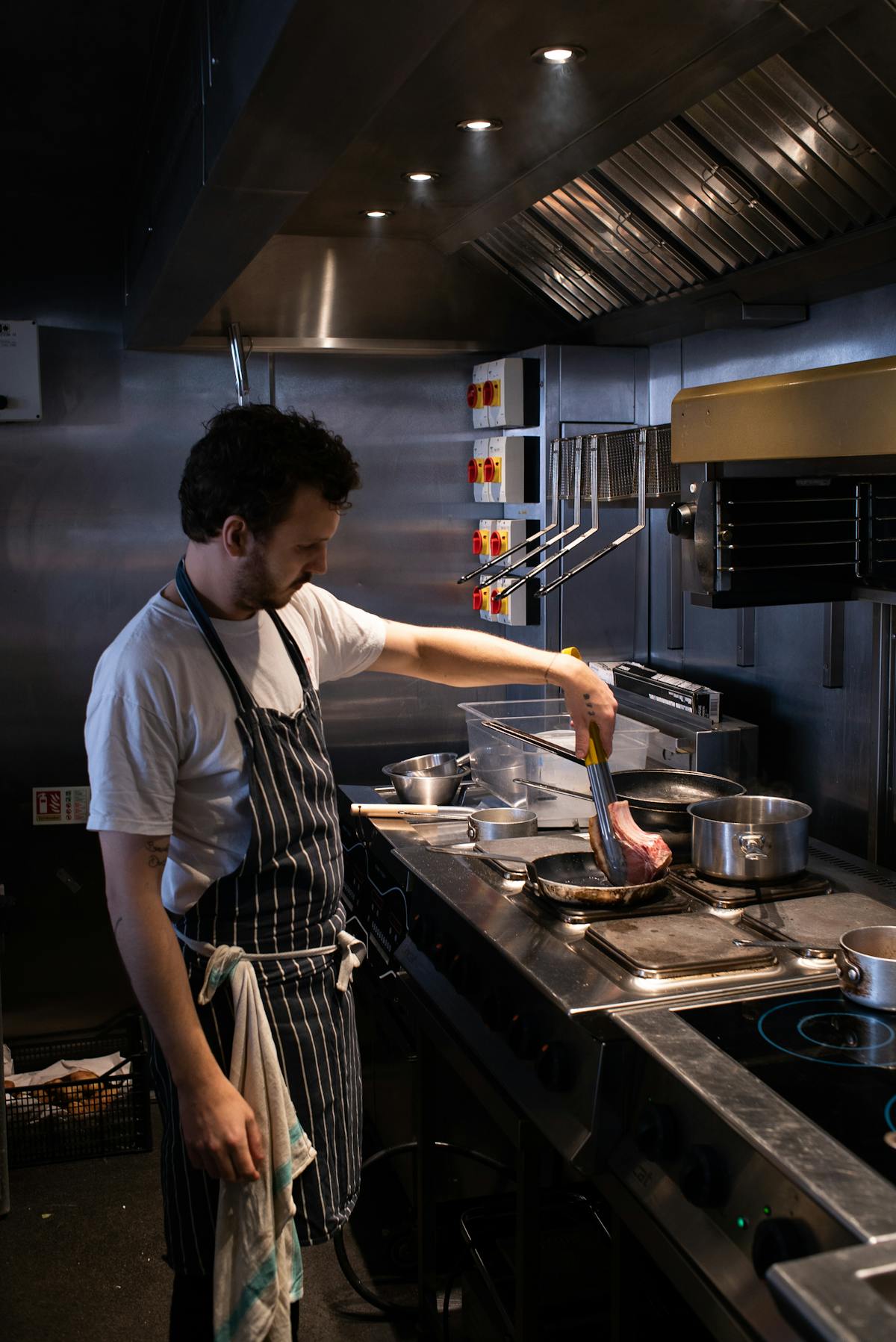 a man standing in a kitchen preparing food