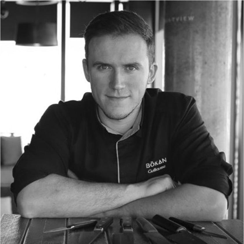 a man sitting in front of a window
