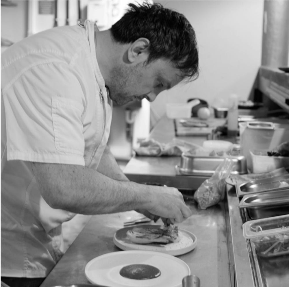 a man preparing food in a kitchen