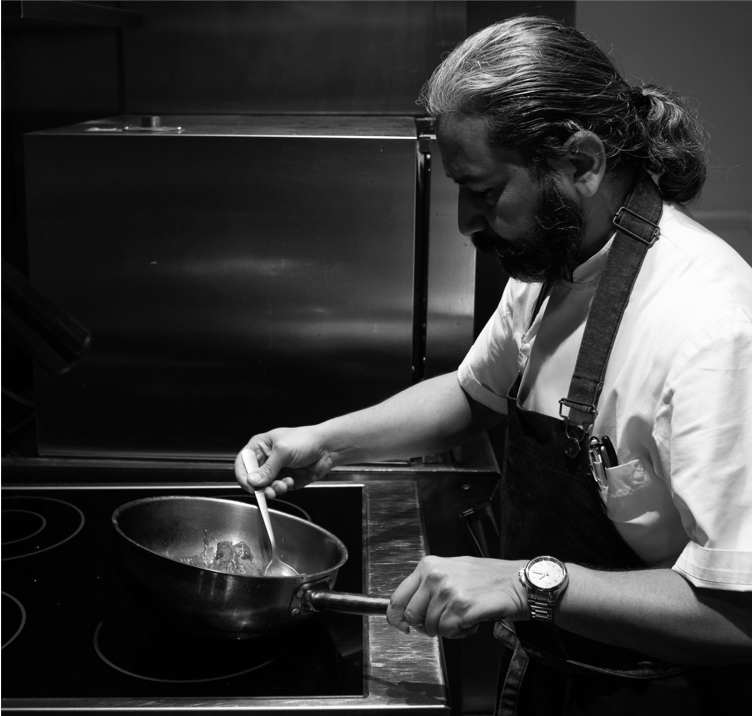 a person cooking food in a kitchen