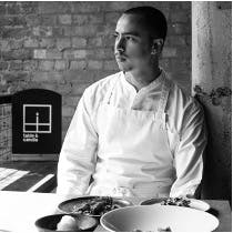 a person sitting at a table with a plate of food