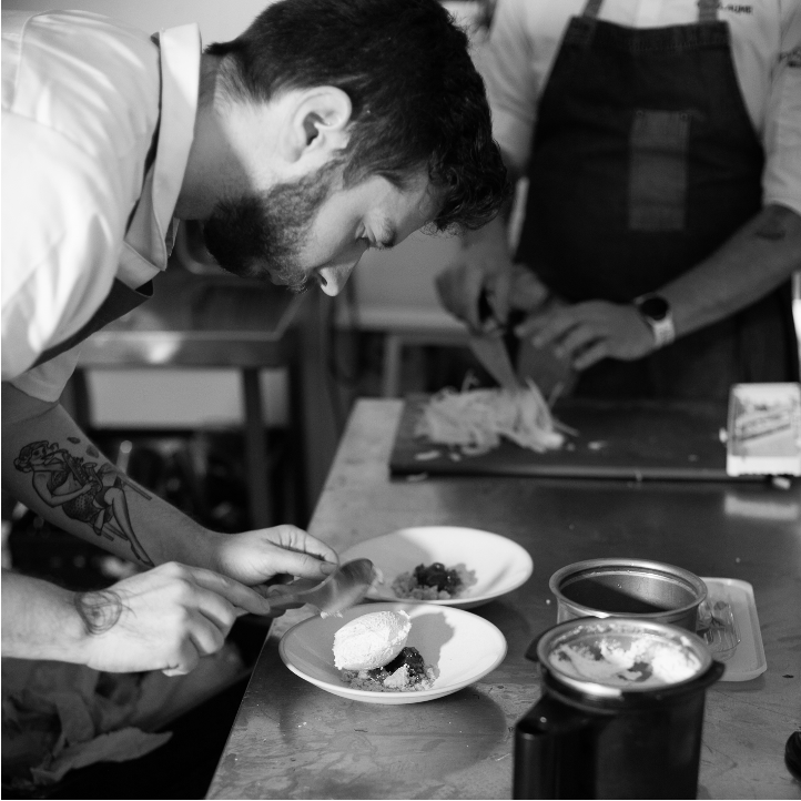 a group of people preparing food on a table
