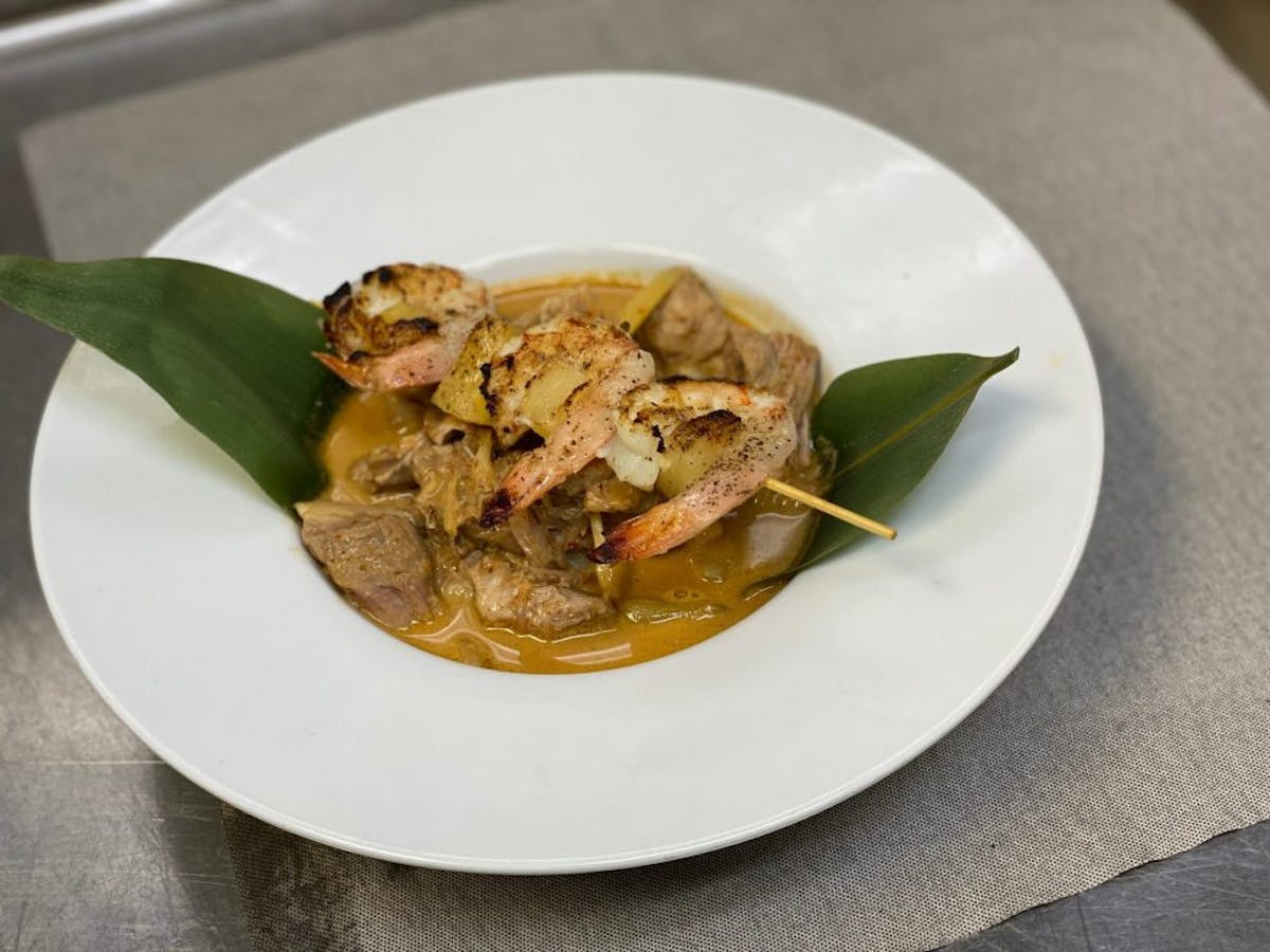 a white plate topped with meat and vegetables