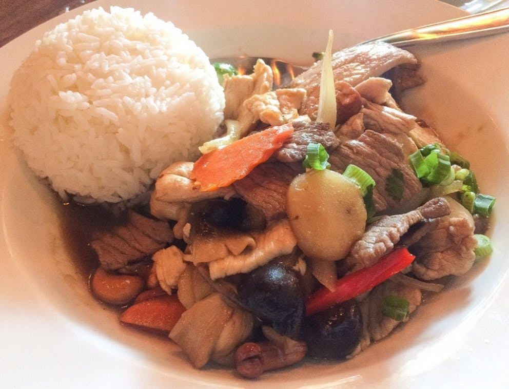 a plate of food with rice meat and vegetables