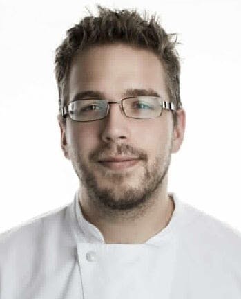 a man wearing glasses posing for the camera