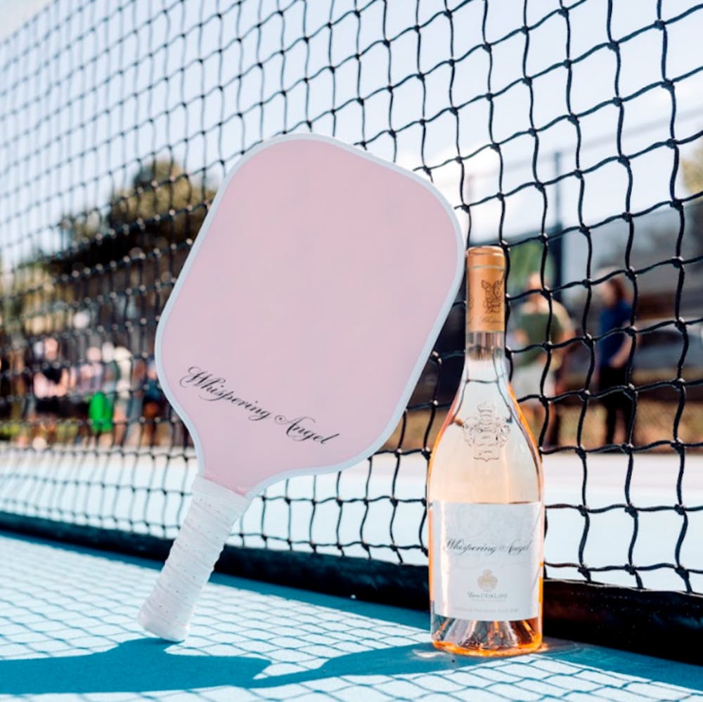 A photo of Whispering Angel Rose and paddle for pickleball