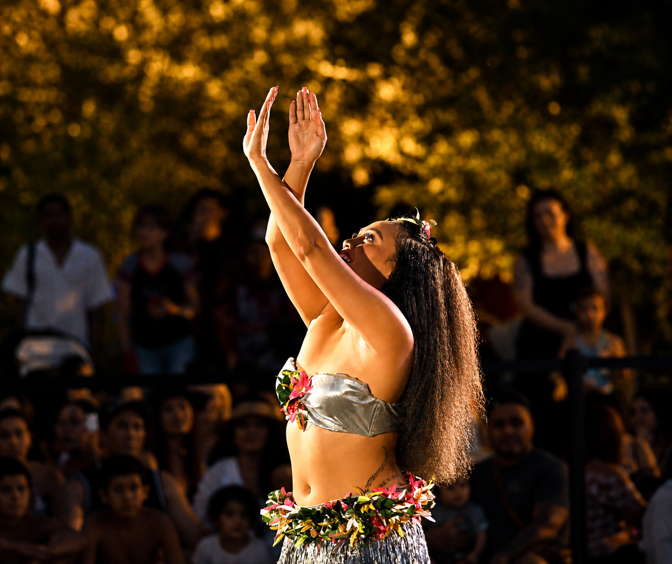 Tahitian dancer performing in front of guests during Aloha Fridays at Bel-Aire Backyard, a vibrant pool near me destination with live island entertainment in Las Vegas.