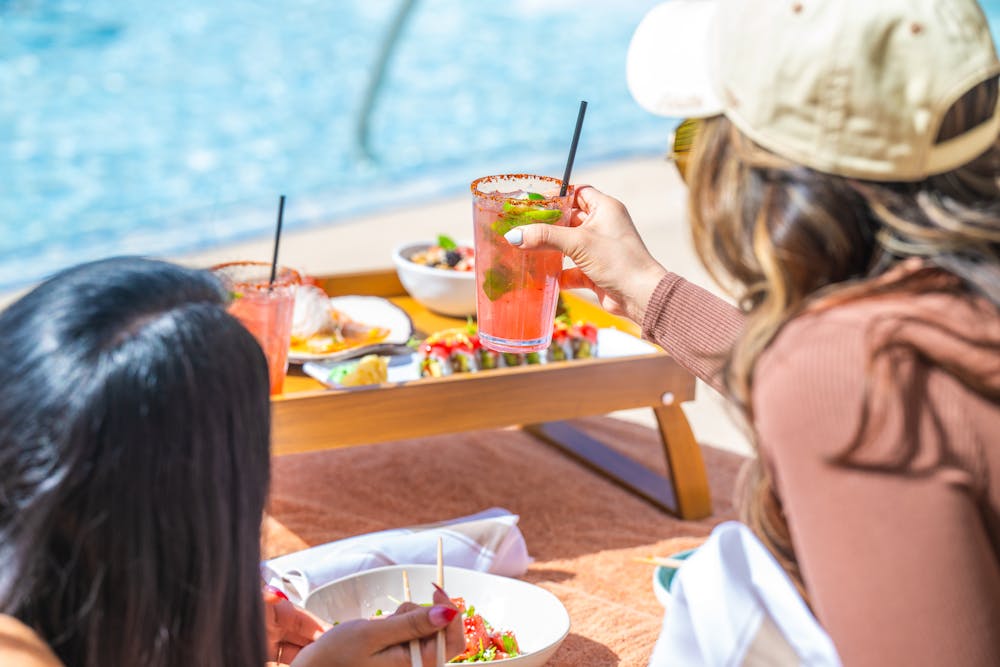 girls with a tray of food and drinks that are outdoor dining at Bel-Aire Backyard