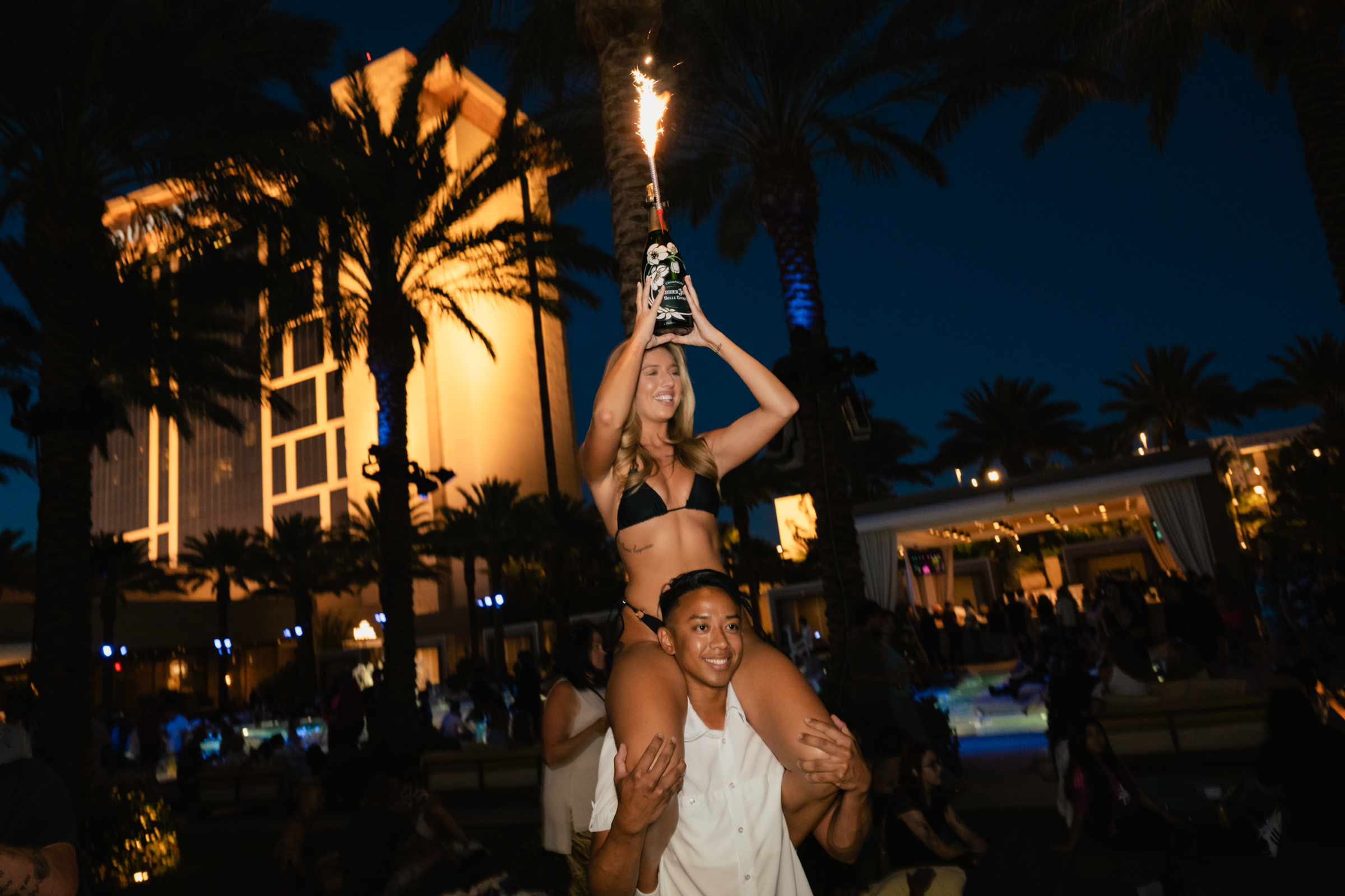 Bottle service celebration during the Poolside Concert Series at Bel-Aire Backyard, featuring live music and resort pool nightlife at Durango Resort.