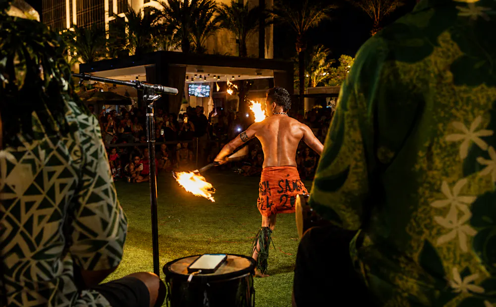 Fire knife performer entertaining guests during Aloha Fridays at Bel-Aire Backyard, a best local pool experience featuring Hawaiian entertainment and live music in Las Vegas.