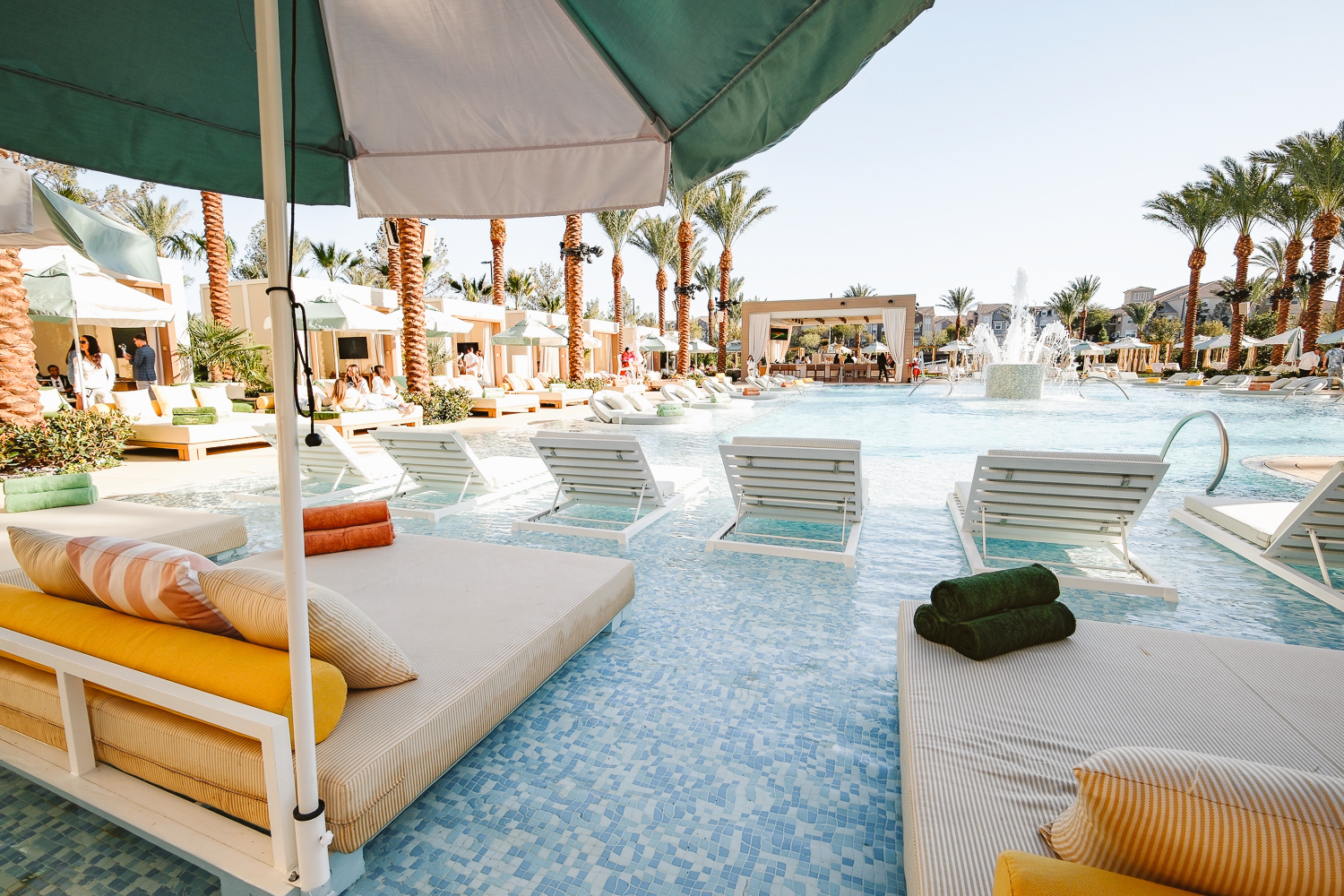 Panoramic view of Bel-Aire Backyard resort pool featuring luxury cabanas, in-water loungers, and palm trees at Durango Casino, the perfect pool near me and local pool party destination in Las Vegas.