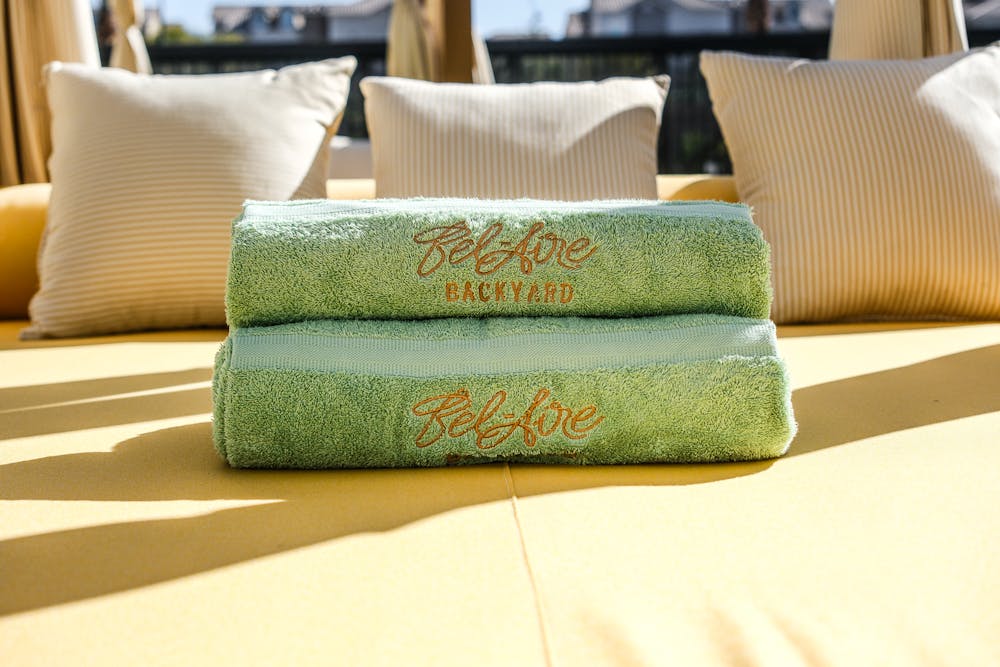 a photo of Bel-Aire Backyard towels rolled up on a daybed at the Las Vegas pool bar