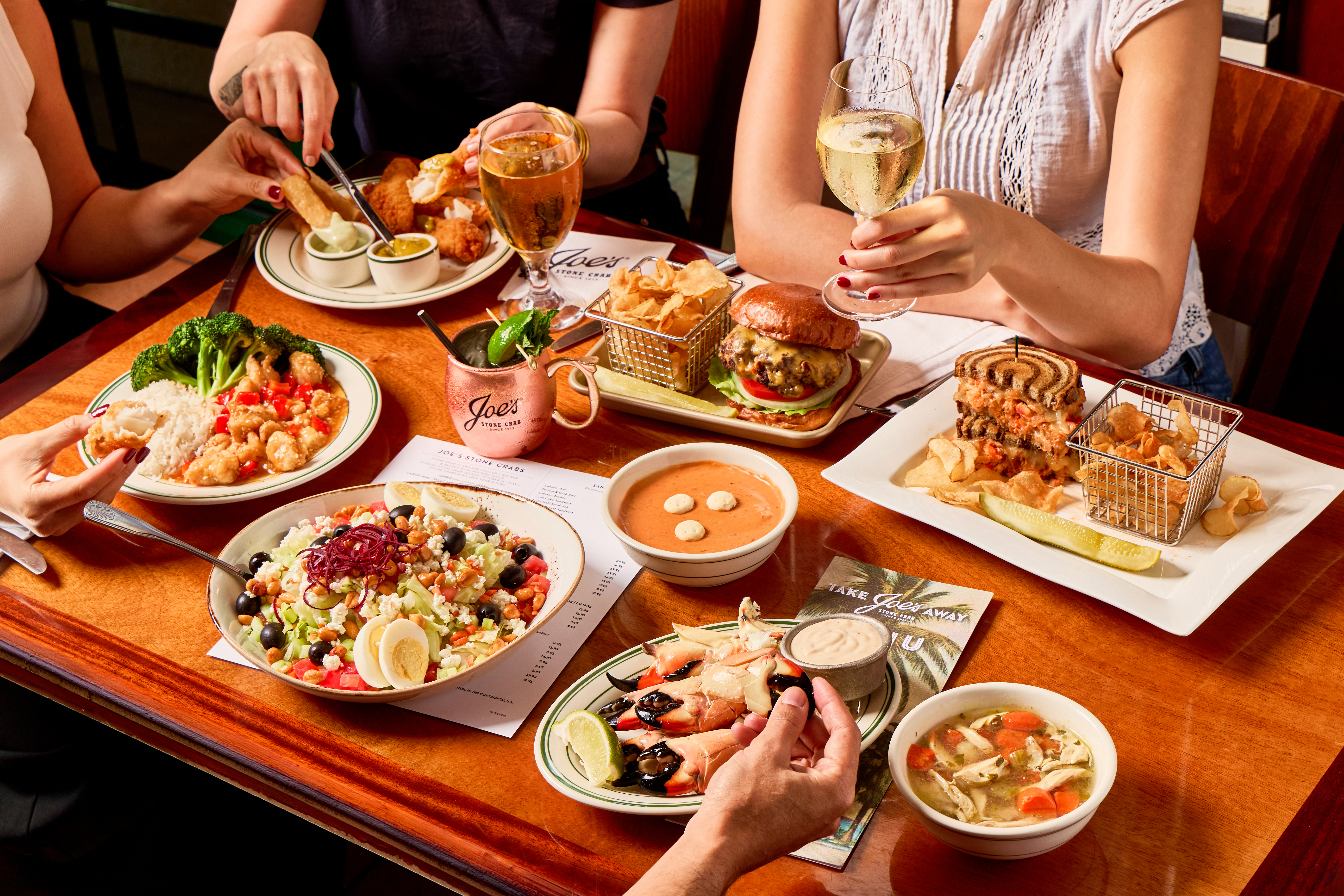 a group of people sitting at a table with food