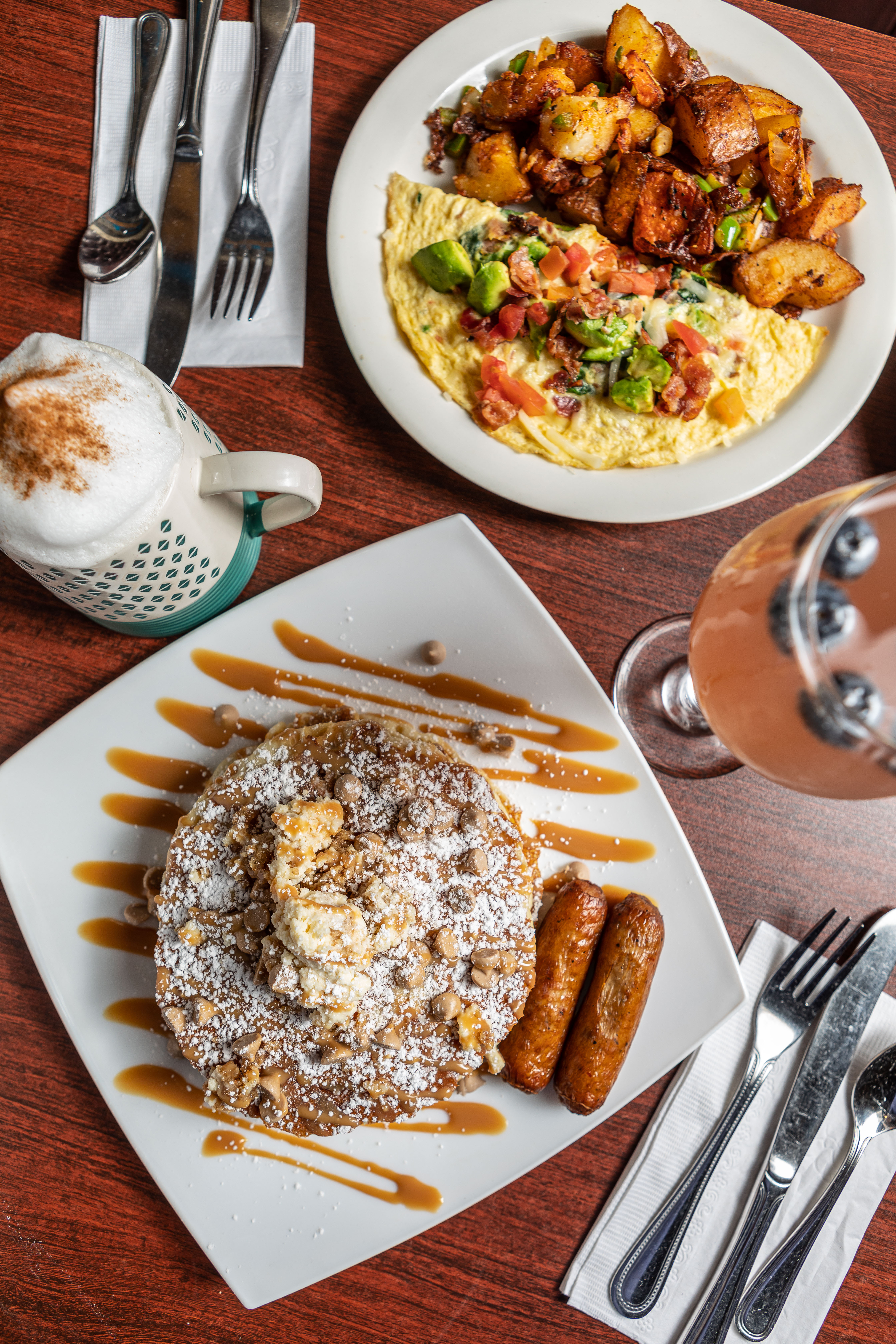 Caramel cheesecake pancakes with sausage and a bacon & avocado omelet with a cappuccino