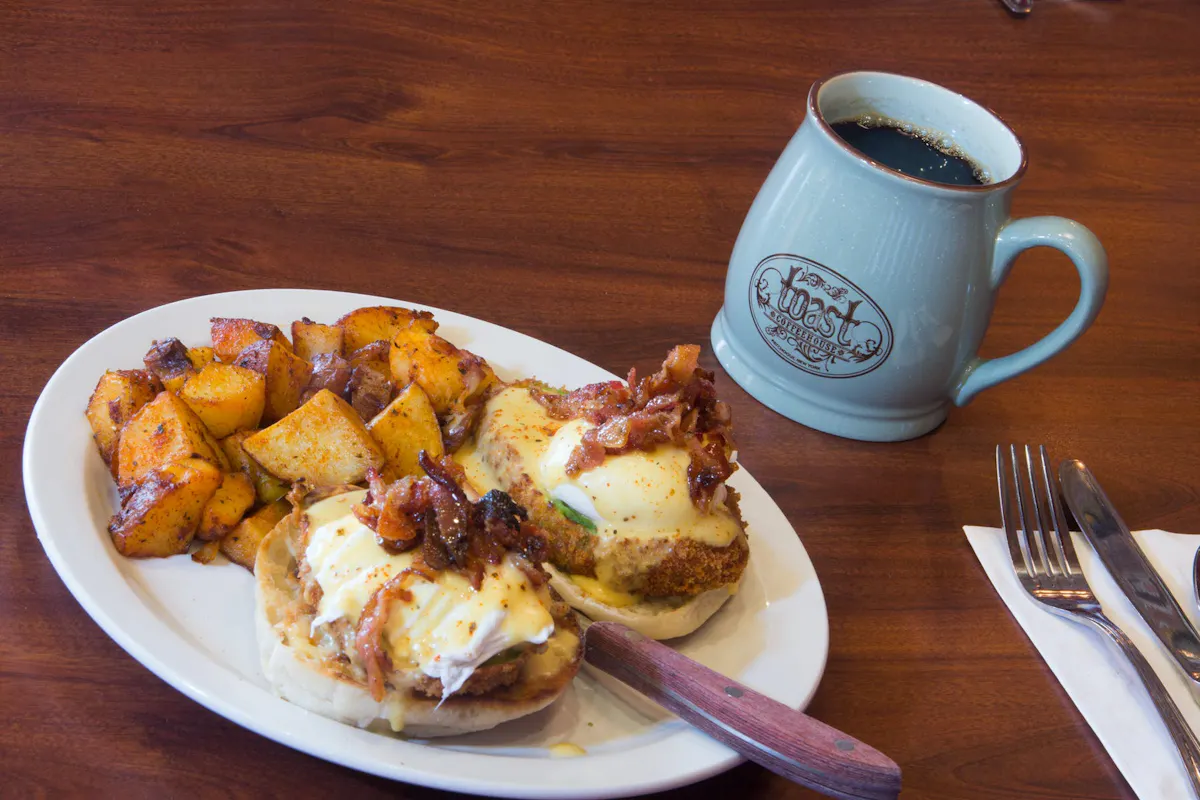 a plate of food and a cup of coffee
