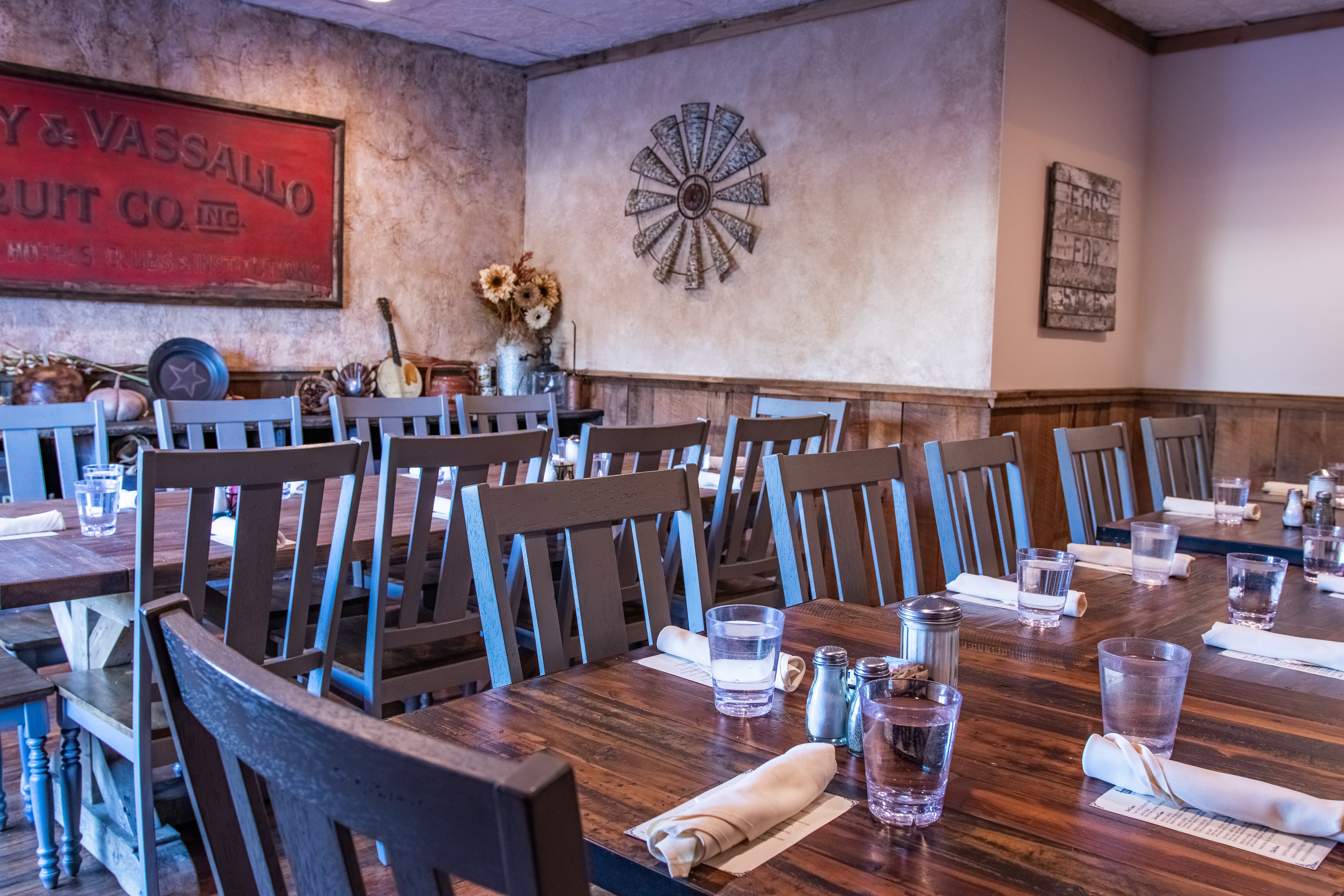 BARN ROOM- location in Port Jefferson Station that shows rustic decor and large farmhouse table that is set for a private event