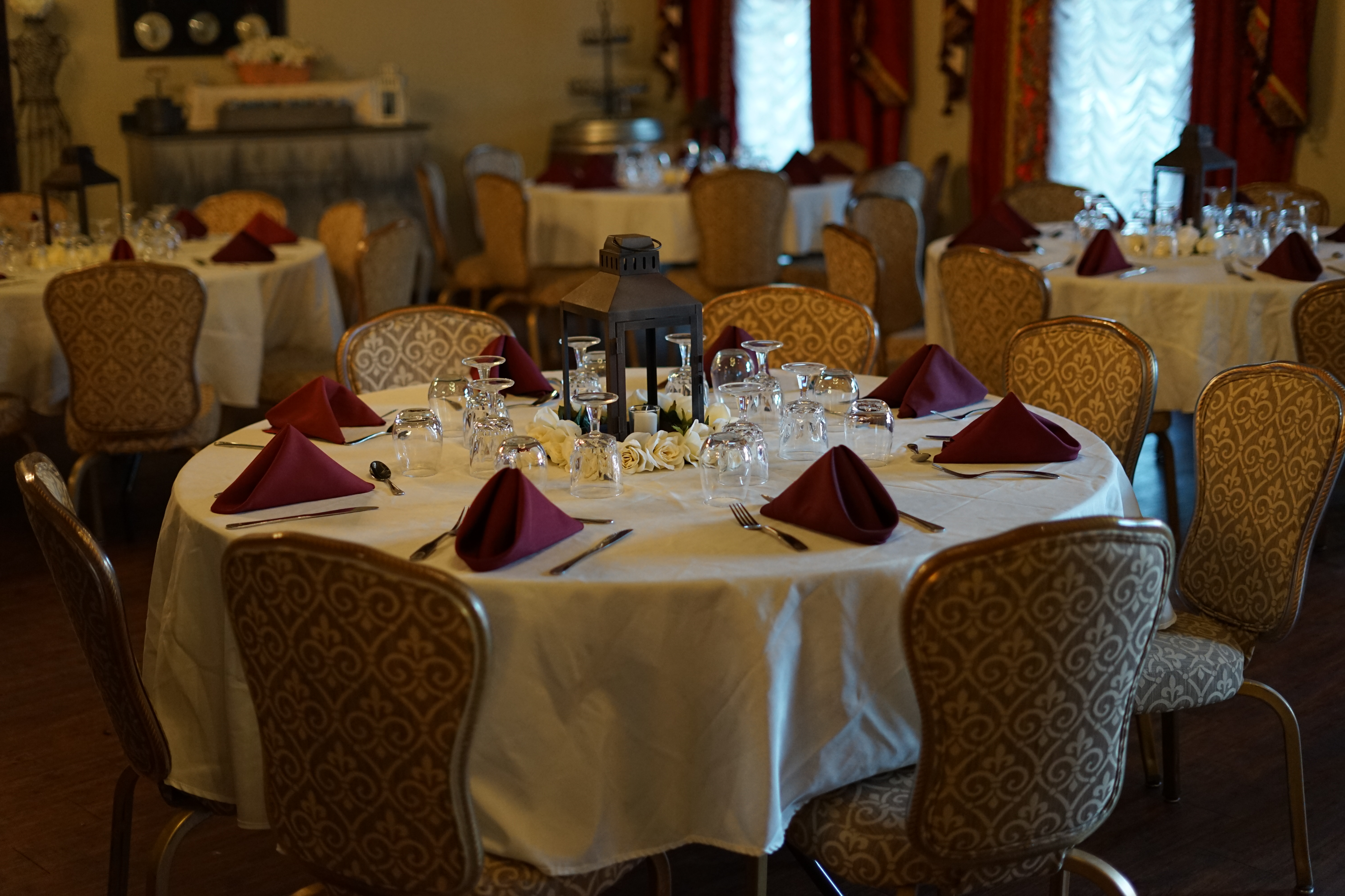 photo of table set for an event with linen table cloths, napkins and glassware