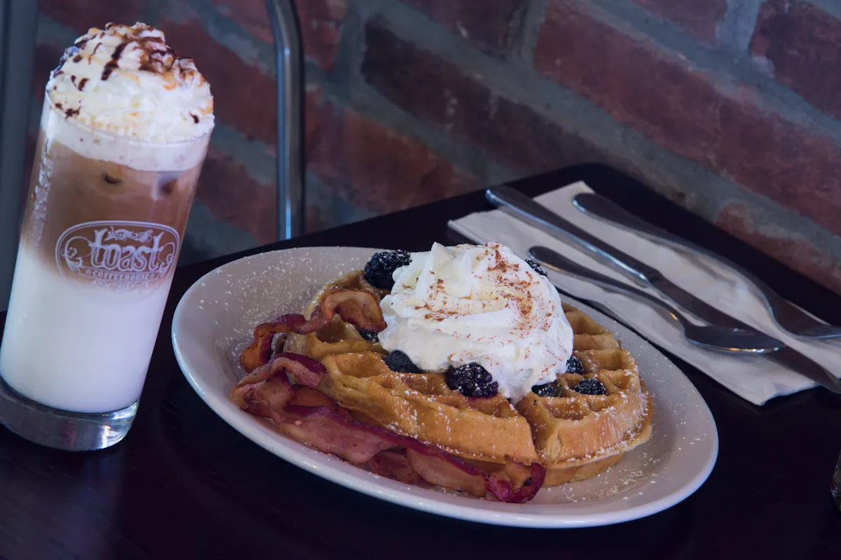 a dessert on a plate next to a cup of coffee