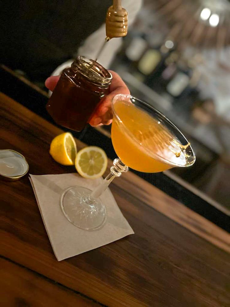 a glass of wine sitting on top of a wooden table