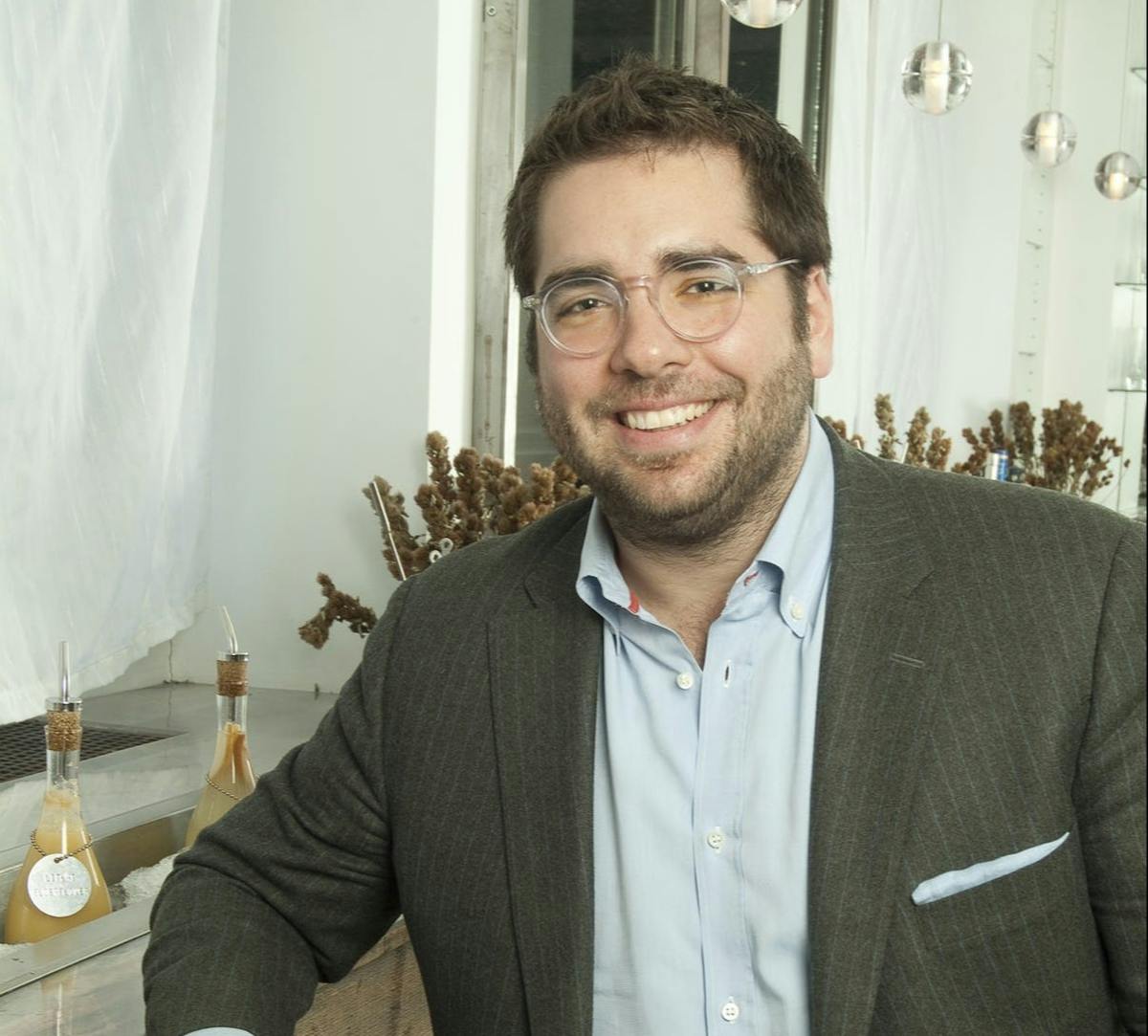a man wearing glasses posing for the camera