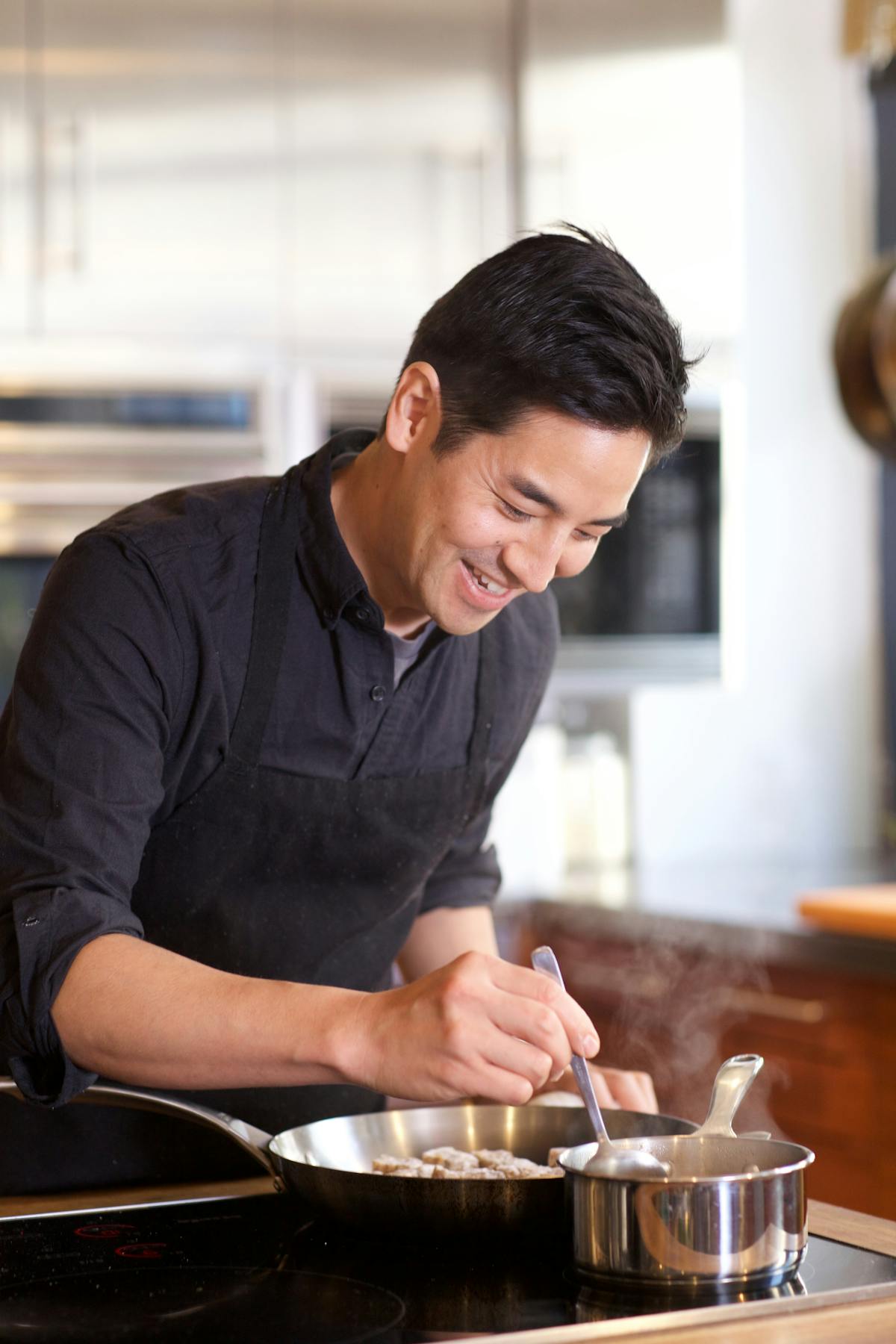 a man cooking in a kitchen preparing food