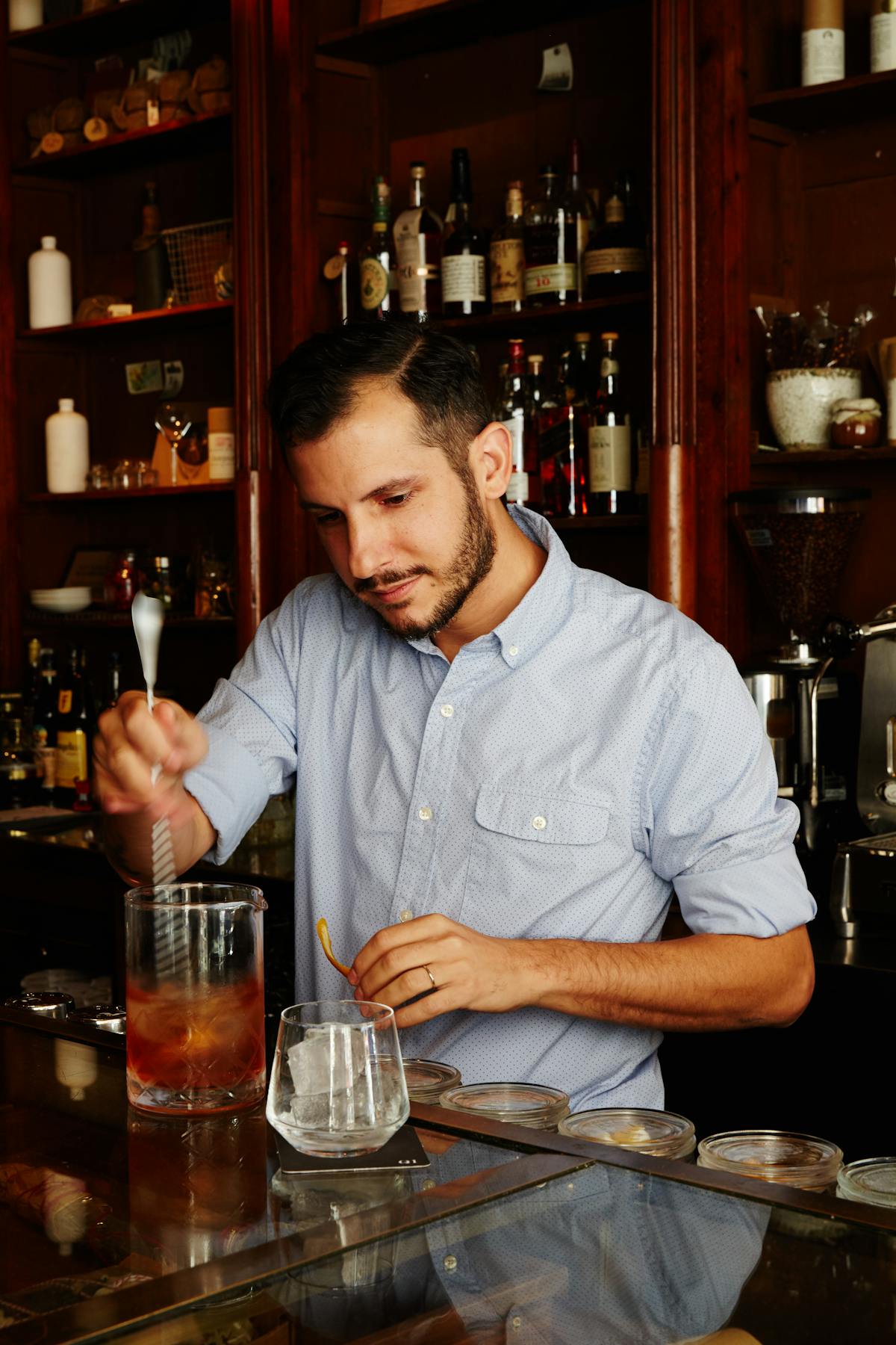 a man sitting at a table with wine glasses