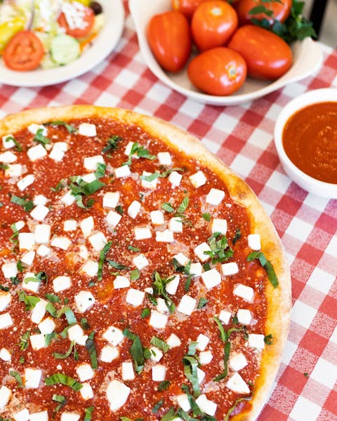 a pizza sitting on top of a plate of food