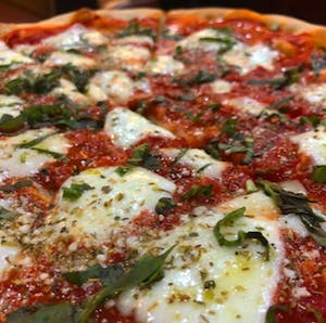 a large pizza covered in cheese