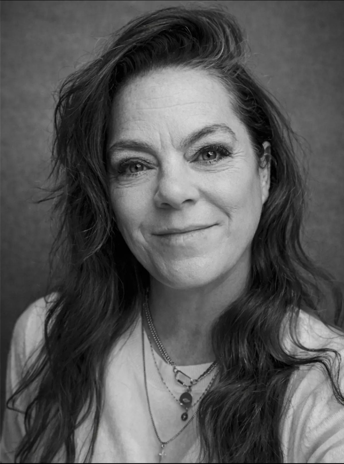 a woman with long hair smiling