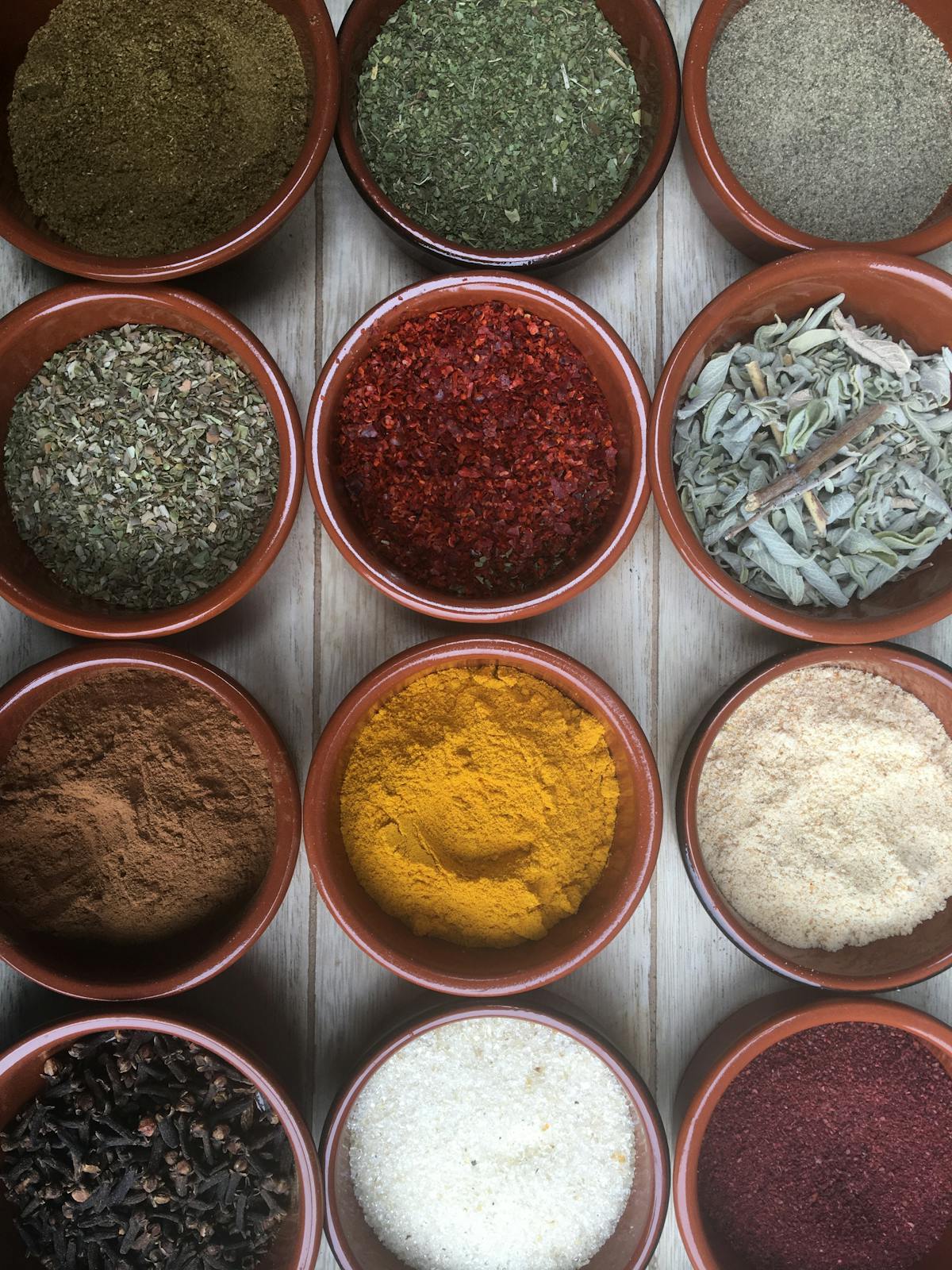 a close up of many different types of spices on a table