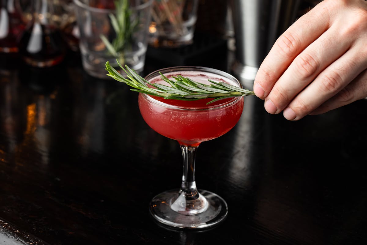 a hand holding a glass of wine
