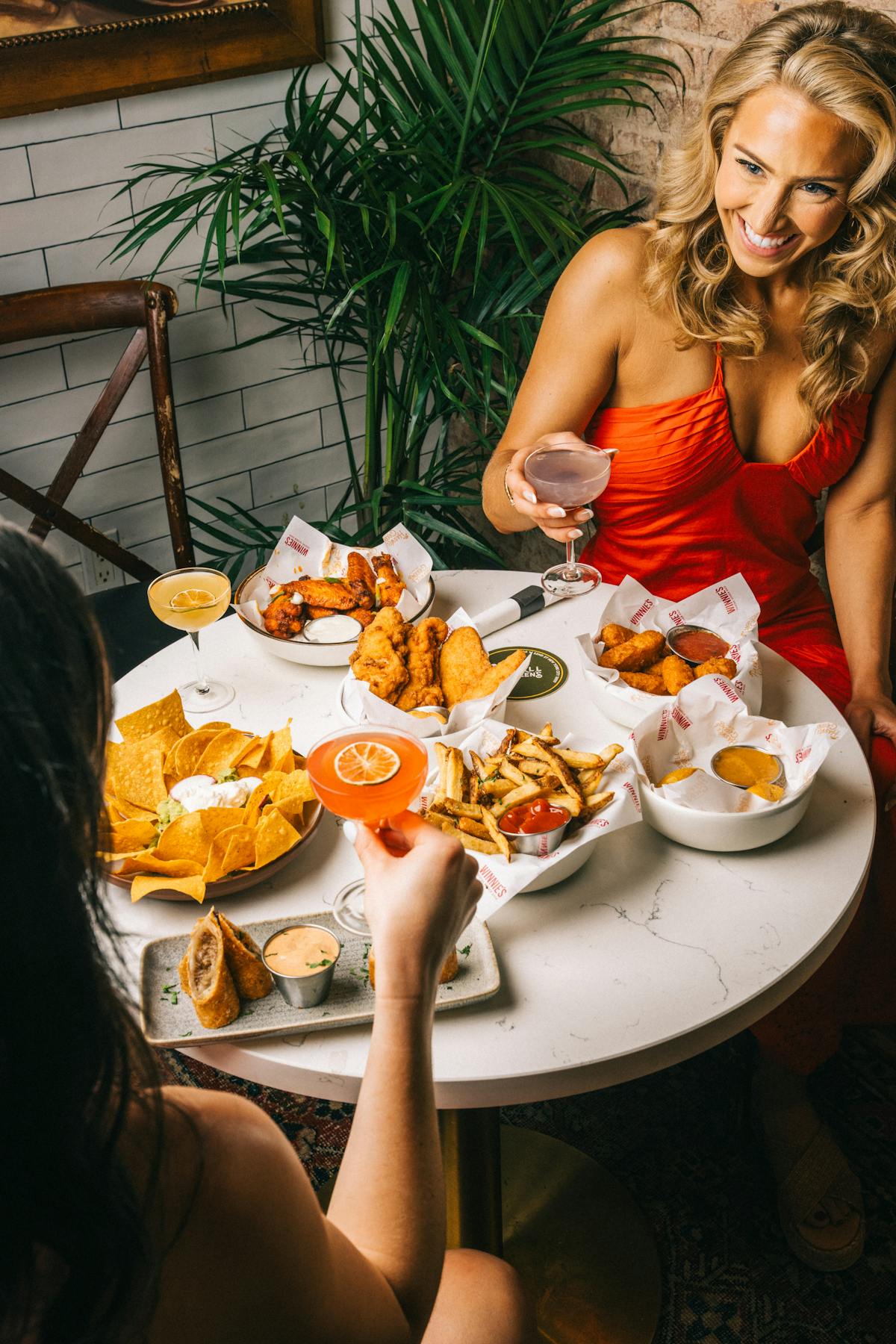 a woman sitting at a table eating food